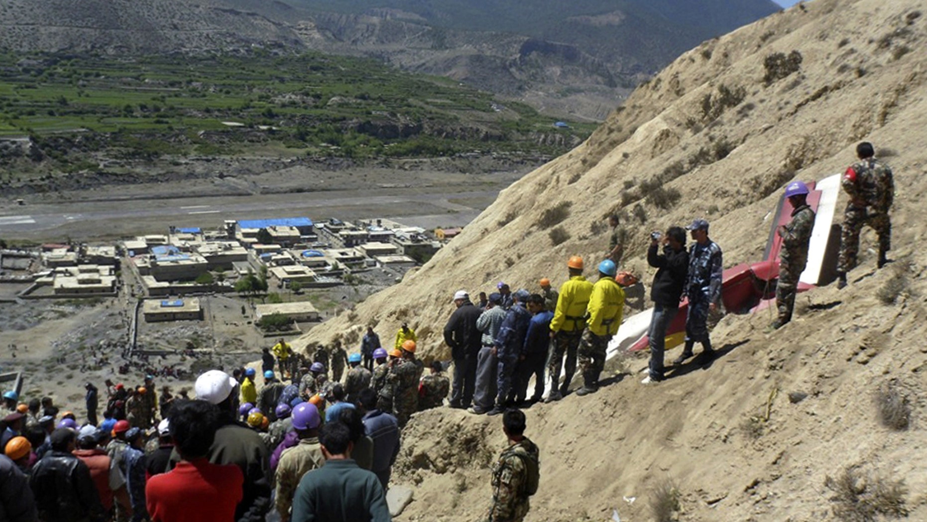 May 14: Nepalese rescue workers and officials inspect the site of a plane crash near Jomsom, 125 miles northwest of the capital, Katmandu.