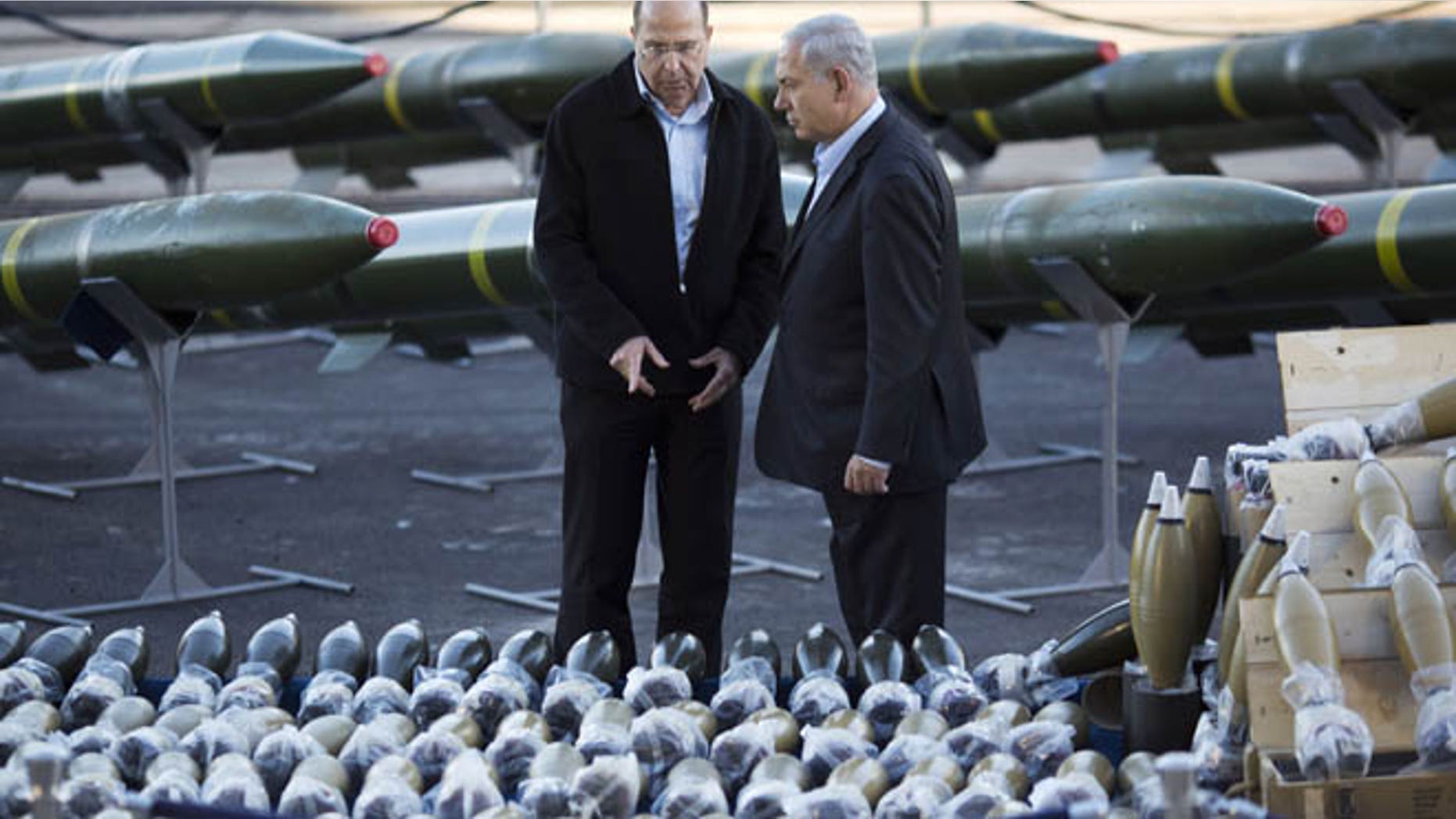 March 10, 2014: Israel's Prime Minister Benjamin Netanyahu, right, and Israel's Defense Minister Moshe Yaalon, left, examine dozens of mortar shells and rockets on display after being seized from the Panama-flagged KLOS C civilian cargo ship that Israel intercepted last Wednesday off the coast of Sudan, at a military port in the Red Sea city of Eilat, southern Israel.