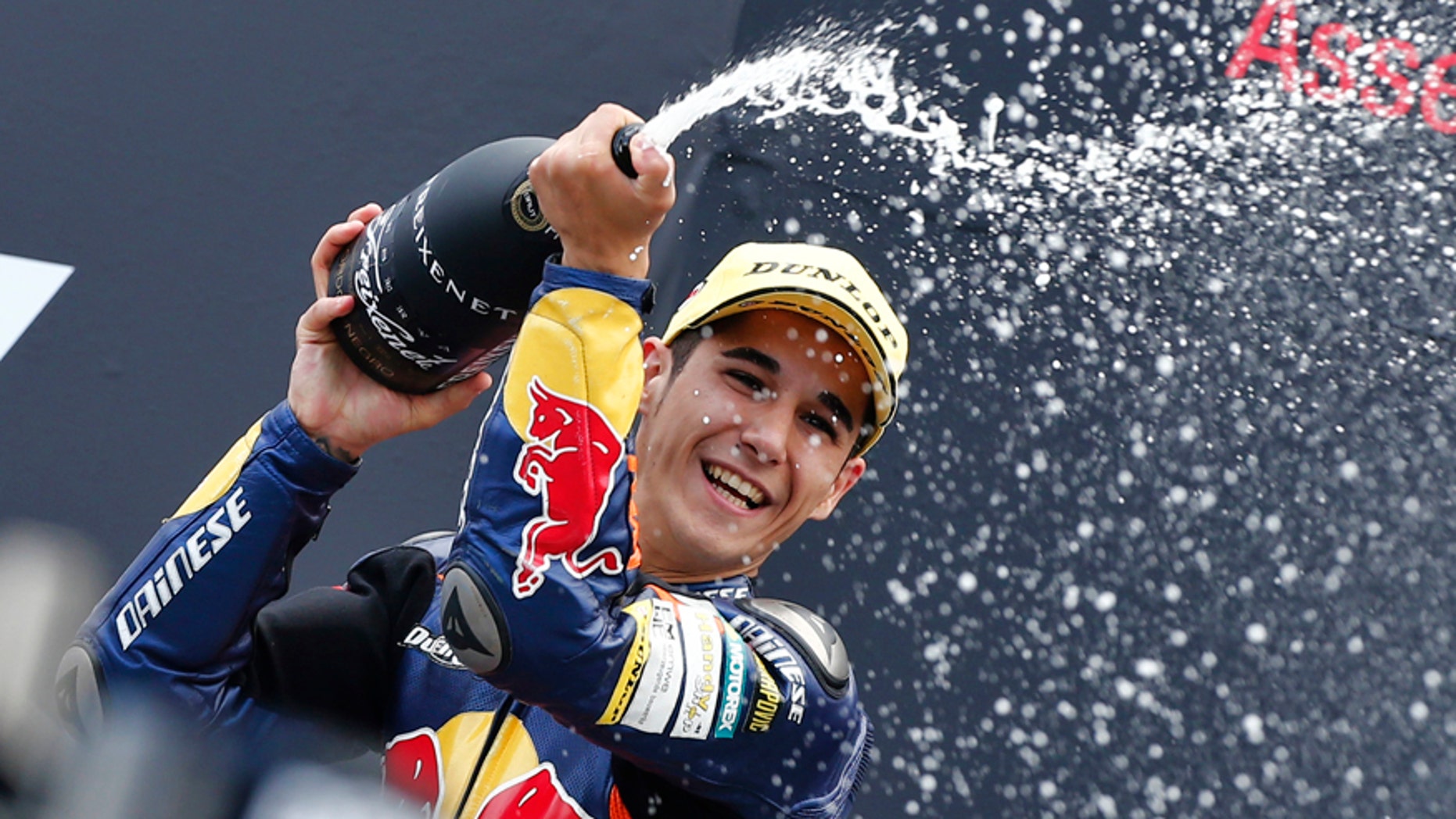 FILE, In this Saturday June 29 2013 file photo, Luis Salom of Spain celebrates his victory during the podium ceremony of the Moto3 race of the Dutch Grand Prix in Assen, northern Netherlands. MotoGP officials say Moto2 rider Luis Salom has died after crashing during practice for the Catalunya Grand Prix on Friday. He was 24. The death was announced at a news conference at the Barcelona circuit. (AP Photo/Vincent Jannink, File)