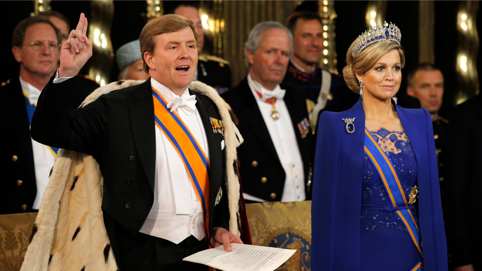 Dutch King Willem-Alexander takes the oath as he wife Queen Maxima stands at his side during his inauguration inside the Nieuwe Kerk or New Church in Amsterdam, The Netherlands, Tuesday April 30, 2013. Around a million people are expected to descend on the Dutch capital for a huge street party to celebrate the first new Dutch monarch in 33 years. (AP Photo/Peter Dejong, Pool)