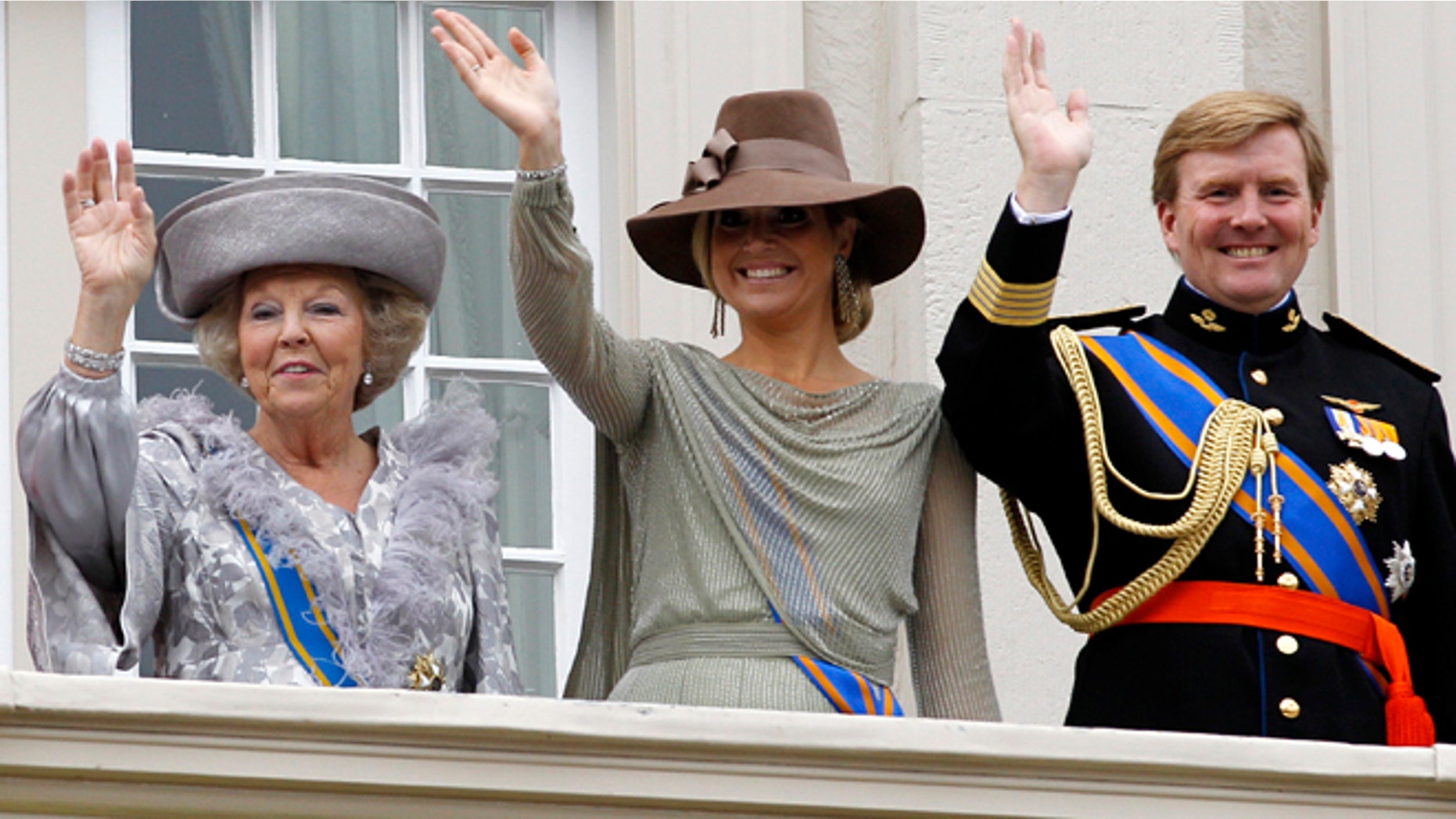 FILE - In this Sept. 20, 2011 file photo, Dutch Queen Beatrix, left, Crown Prince Willem Alexander, right, and his wife Princess Maxima, center, wave to wellwishers from the balcony of Royal Palace Noordeinde after the Queen officially opened the new parliamentary year in The Hague, Netherlands. Queen Beatrix announced she is to abdicate in favor of Crown Prince Willem Alexander during a nationally televised speech Monday, Jan. 28, 2013. Beatrix, who turns 75 on Thursday, has ruled the nation of 16 million for more than 32 years and would be succeeded by her eldest son, Crown Prince Willem-Alexander. (AP Photo/Bas Czerwinski, File)