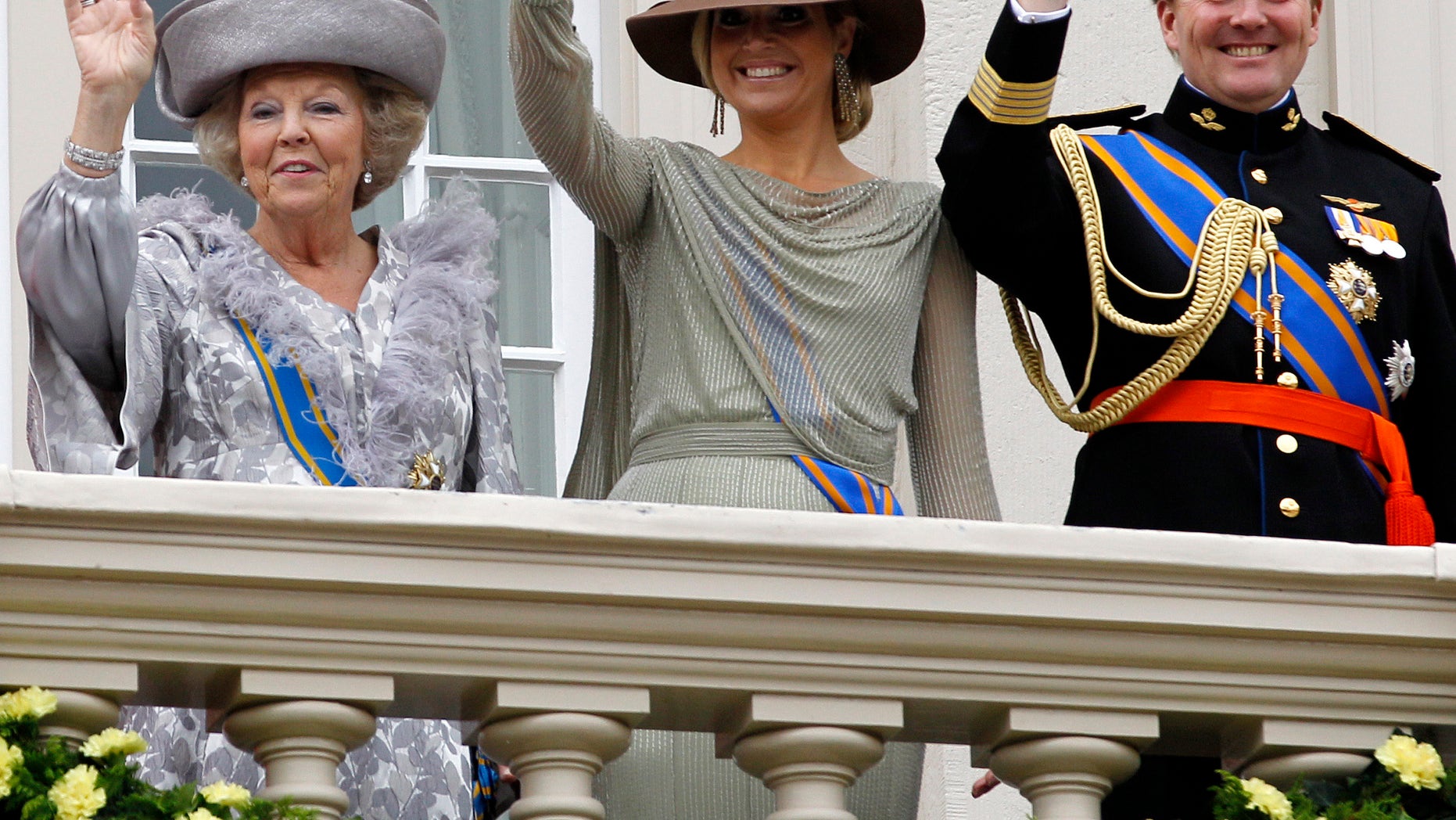 Sept. 20, 2011 - FILE photo of Dutch Queen Beatrix, left, Crown Prince Willem Alexander, right, and his wife Princess Maxima, center, wave to wellwishers from the balcony of Royal Palace Noordeinde.