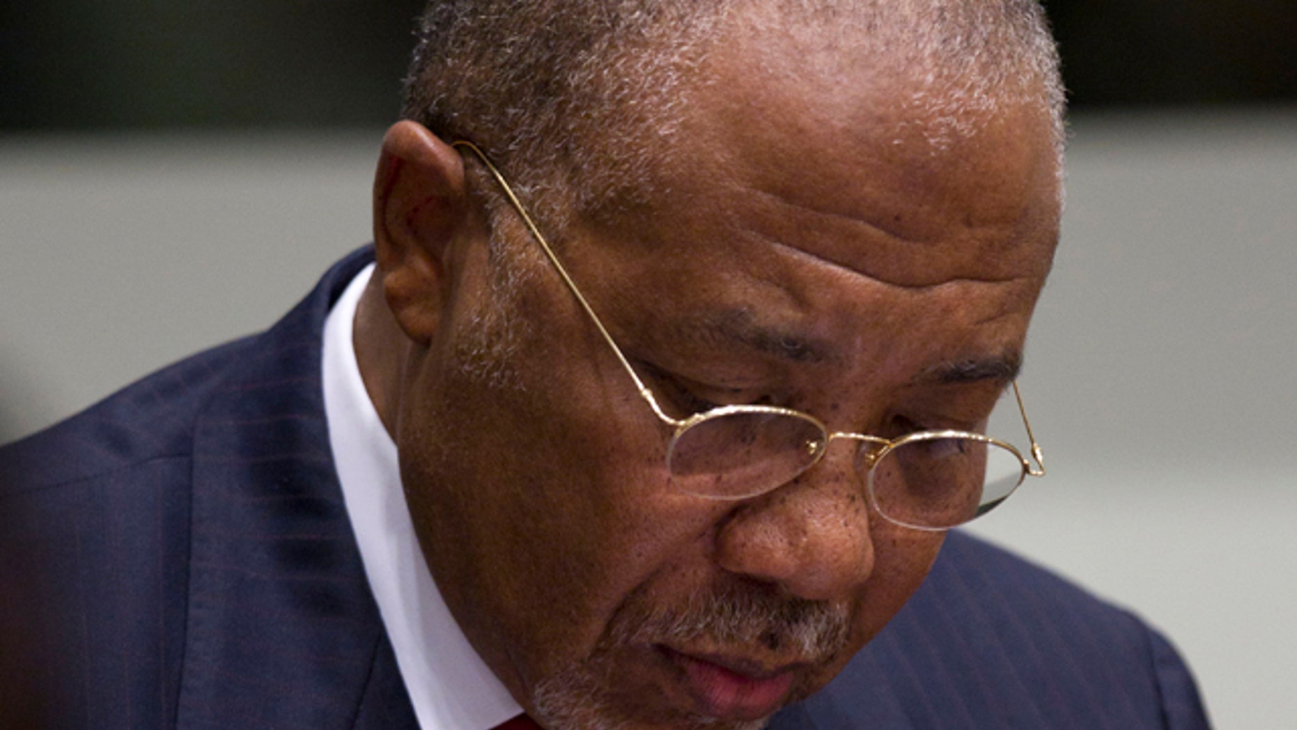 April 26, 2012: Former Liberian President Charles Taylor takes notes as he waits for the start of a hearing to deliver verdict in the court room of the Special Court for Sierra Leone in Leidschendam, near The Hague, Netherlands.