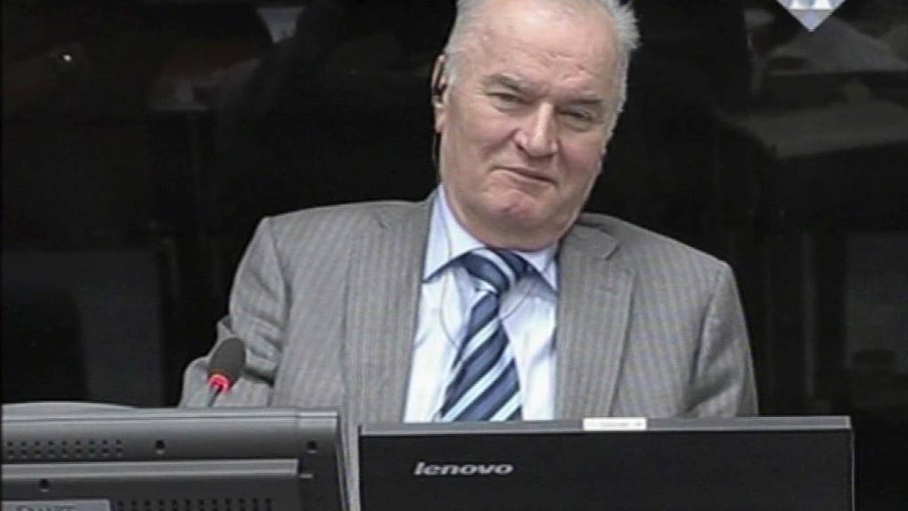 FILE - In this Jan. 28, 2014 file image taken from video former Bosnian Serb military chief Gen. Ratko Mladic smiles during his appearance at the Yugoslav war crimes tribunal in the Hague, Netherlands. On Monday, May 19, 2014 Mladic has launched the defense case in his long-running U.N. trial by calling a former Serb army officer who claims he was never ordered to fire on civilians in the besieged Bosnian capital. The 72-year-old Mladic denies 11 charges of ordering Serb atrocities throughout the 1991-95 Bosnian war. He faces a life sentence if convicted. (AP Photo/ICTY, Via Associated Press Television, File) TV OUT