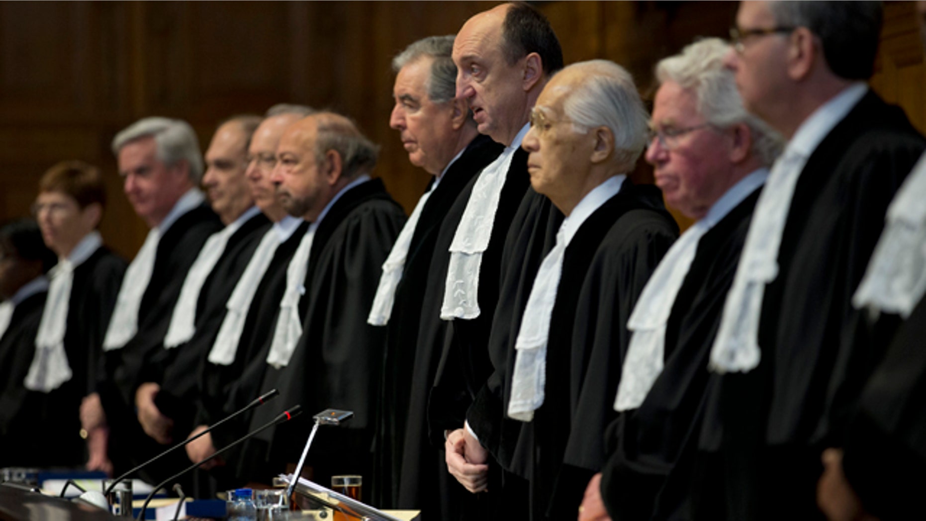 Feb. 3, 2015: Presiding judge Peter Tomka of Slovakia, fourth from right, opens the World Court session in The Hague, Netherlands. (AP Photo/Peter Dejong)