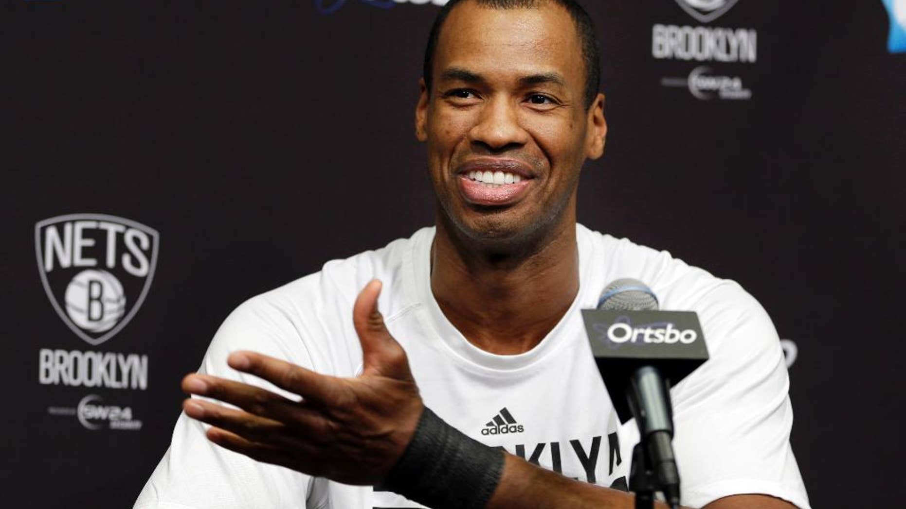 Brooklyn Nets Jason Collins speaks during a news conference before an NBA basketball game against the Chicago Bulls at the Barclays Center, Monday, March 3, 2014, in New York. More than a week after becoming the league's first openly gay player, Collins will finally get to play a home game. (AP Photo/Seth Wenig)