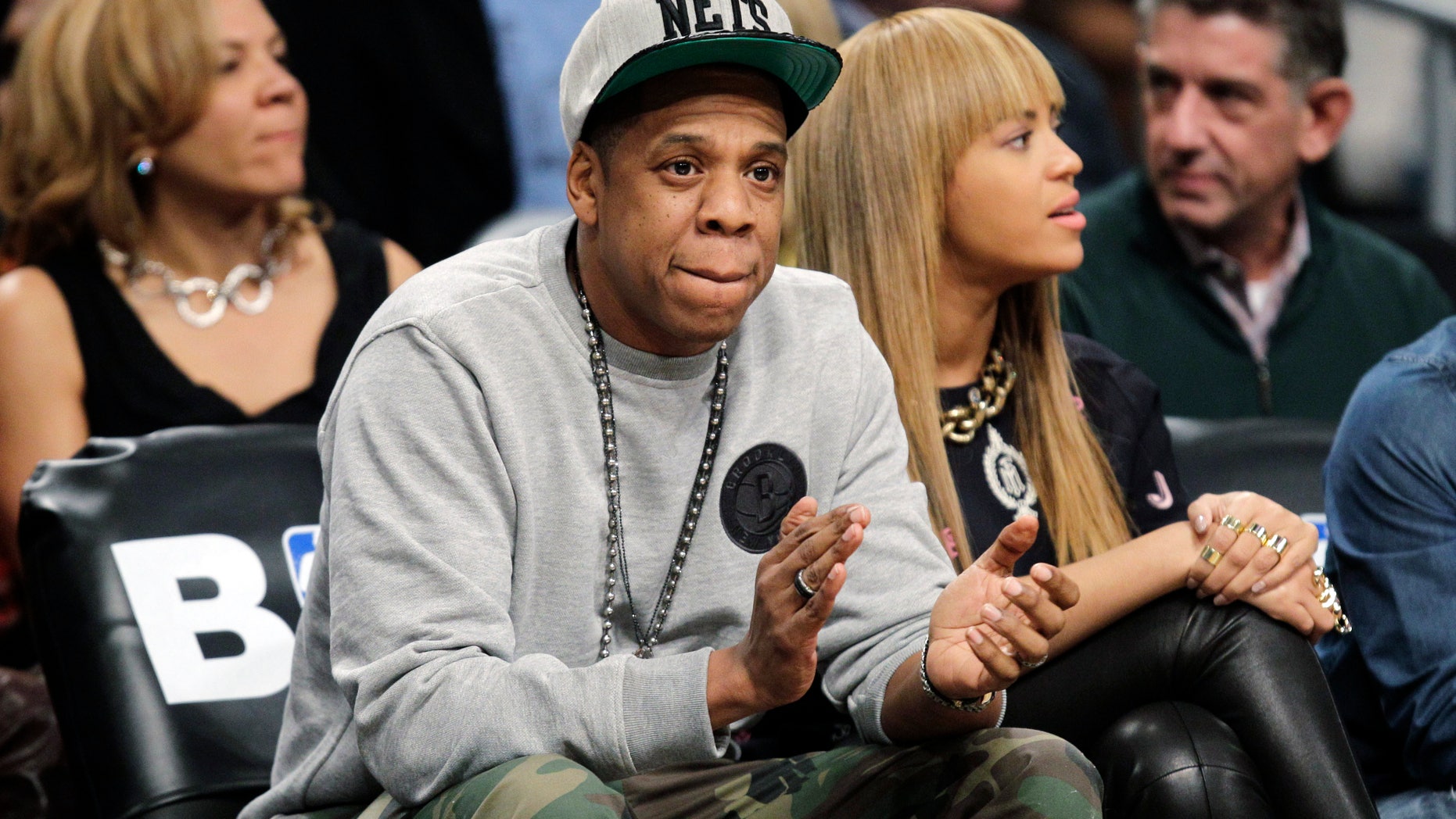 In this Nov. 26, 2012, file photo, rap mogul and Brooklyn Nets minority owner Jay-Z and his wife, Beyonce, watch an NBA basketball game between the Nets and the New York Knicks at Barclays Center in New York. Jay -Z is selling his stake in the Nets so he can become certified as a player agent, possibly before the end of the season.