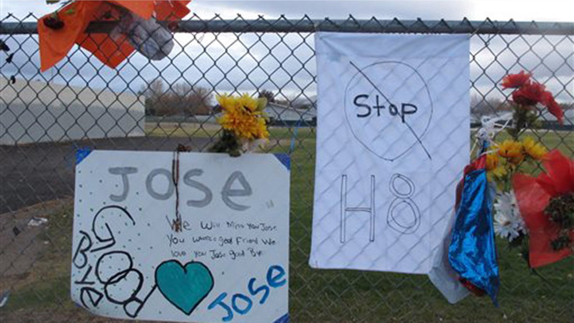 Friends have added a message to Jose Reyes and a small wooden cross at a memorial pictured Monday, Oct. 28, 2013, outside Sparks Middle School, where the seventh-grader fatally shot a teacher and wounded two 12-year-old classmates before killing himself in the school yard a week ago. Students returned to classes Monday for the first time since the Oct. 21 shooting. (AP Photo/By Scott Sonner)