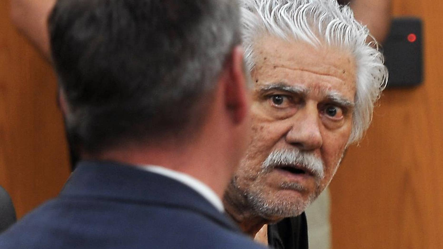 FILE - In this June 2, 2014, file photo, Wayne Burgarello, right, with his public defender Justin Champagne, listens to the judge during his bail hearing in Sparks Justice Court in Sparks, Nev. Burgarello, a former schoolteacher charged with murder and attempted murder in the shootings of two unarmed trespassers at a Sparks home he owned, pleaded not guilty on Wednesday, Sept. 10, 2014 to the charges against him. (AP Photo/The Reno Gazette-Journal, Marilyn Newton, Pool, File)