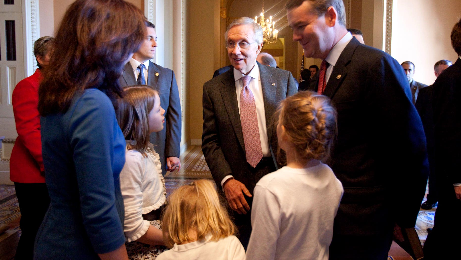 Jan. 5: Senate Majority Leader Harry Reid of Nev., center, talks with Michael Bennet, D-Colo., right, and his family on Capitol Hill.