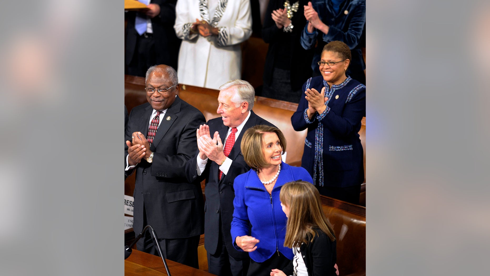 Outgoing House Speaker Nancy Pelosi of California reacts to the applause during the opening session of the 112th Congress. Assistant House Minority Leader James Clyburn of South Carolina is at left and House Minority Whip Steny Hoyer of Maryland stands in the middle.