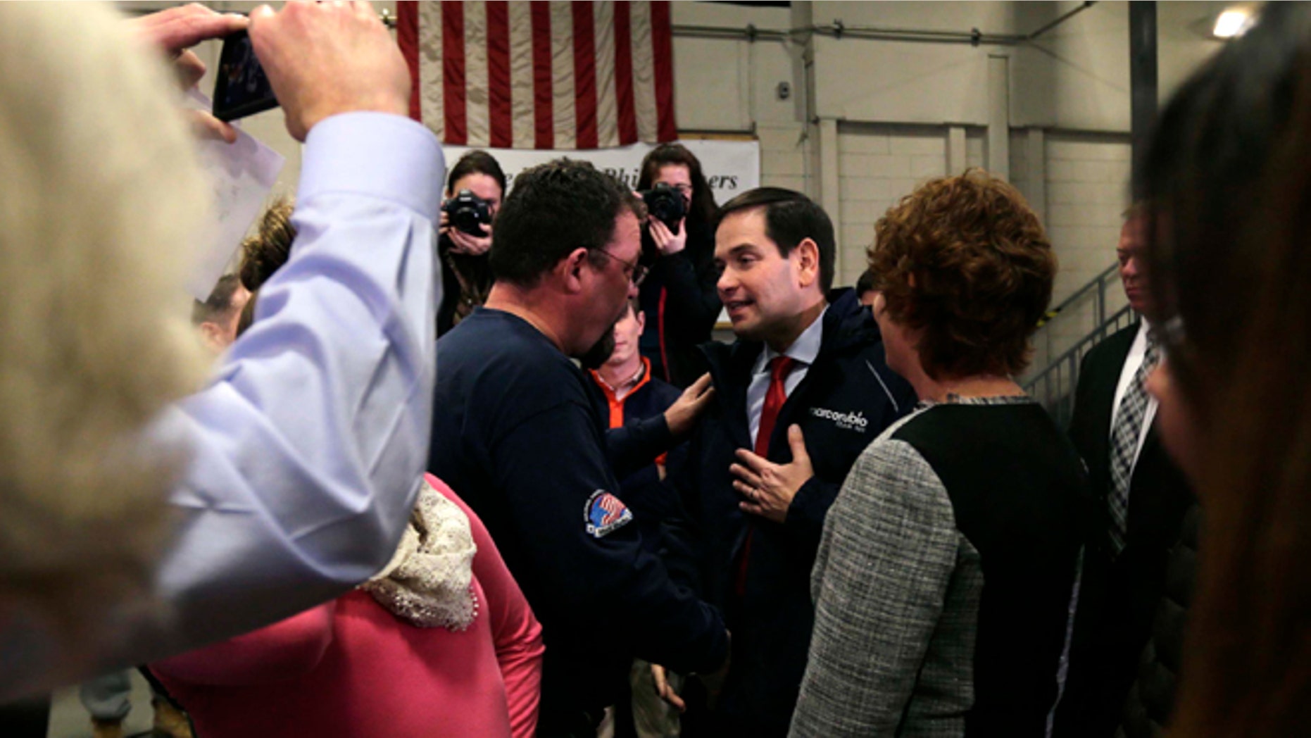In this Jan. 21, 2016, photo Republican presidential candidate, Sen. Marco Rubio, R-Fla., talks with Bob Belanger, from Brookline, N.H., after a campaign stop at a welding company in Brookline. Illegal immigration is a paramount concern to New Hampshire voters, and Republican presidential candidates are being faced with tough questions from voters in this small, mostly white, state on how they will handle the issue if elected. Belanger said immigration concerns among New Hampshire residents do not equate to xenophobia. (AP Photo/Charles Krupa)