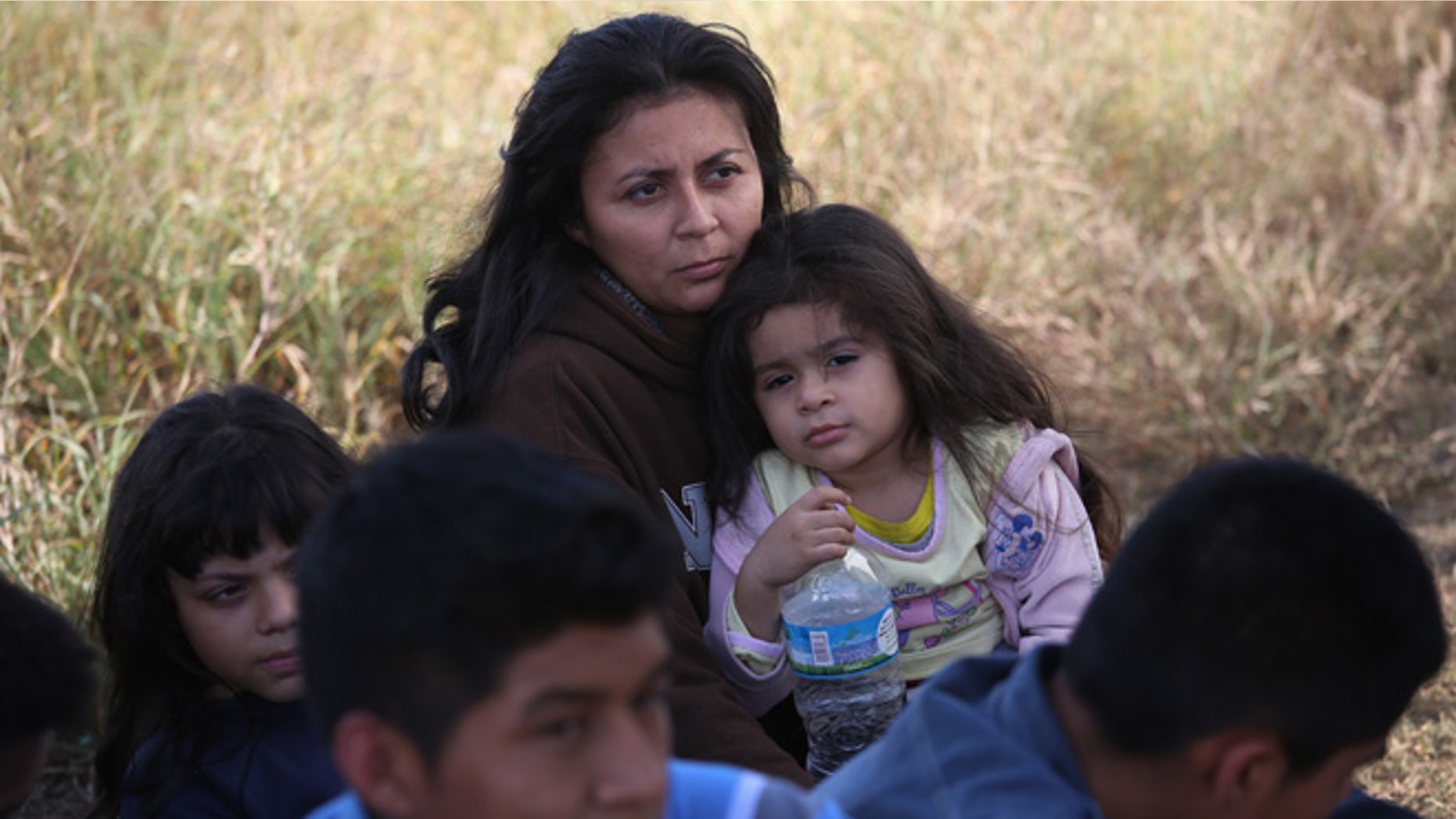 A Honduran mother holds her daughter, 3, after she turned her family in to U.S. Border Patrol agents on December 8, 2015 near Rio Grande City, Texas. They had just illegally crossed the U.S.-Mexico border into Texas. (Photo by John Moore/Getty Images)