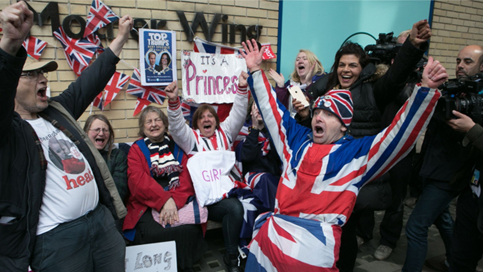 Royal fans and well wishers react after Kensington Palace announced that Kate, the Duchess of Cambridge, had given birth to a girl, outside the Lindo Wing of St. Mary's Hospital, London, Saturday, May 2, 2015. Kensington Palace said in a brief statement that Prince William's wife "was safely delivered of a daughter" at 8:34 a.m. London time (0734 GMT), less than three hours after she was admitted to central London's St. Mary's Hospital. (Daniel Leal-Olivas/PA via AP) UNITED KINGDOM OUT, NO SALES, NO ARCHIVE