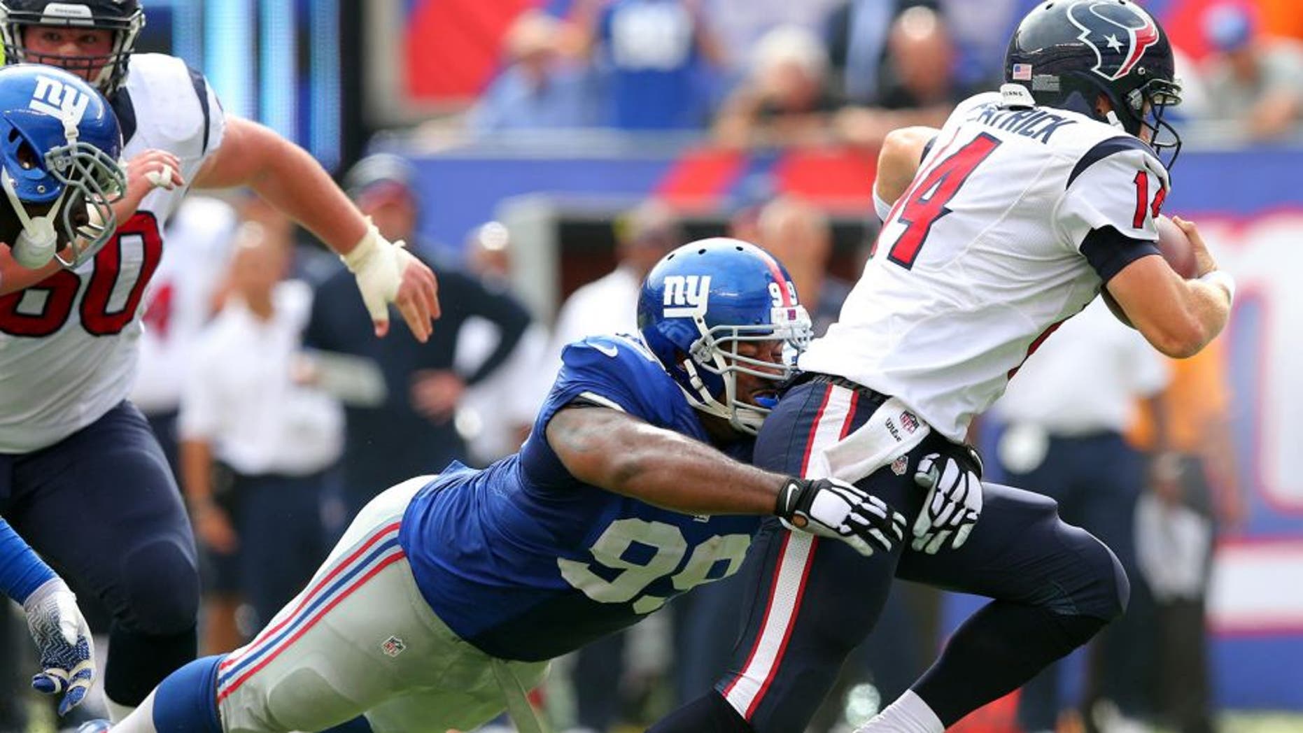 Sep 21, 2014; East Rutherford, NJ, USA; New York Giants defensive tackle Cullen Jenkins (99) pressures Houston Texans quarterback Ryan Fitzpatrick (14) during the third quarter at MetLife Stadium. Mandatory Credit: Brad Penner-USA TODAY Sports