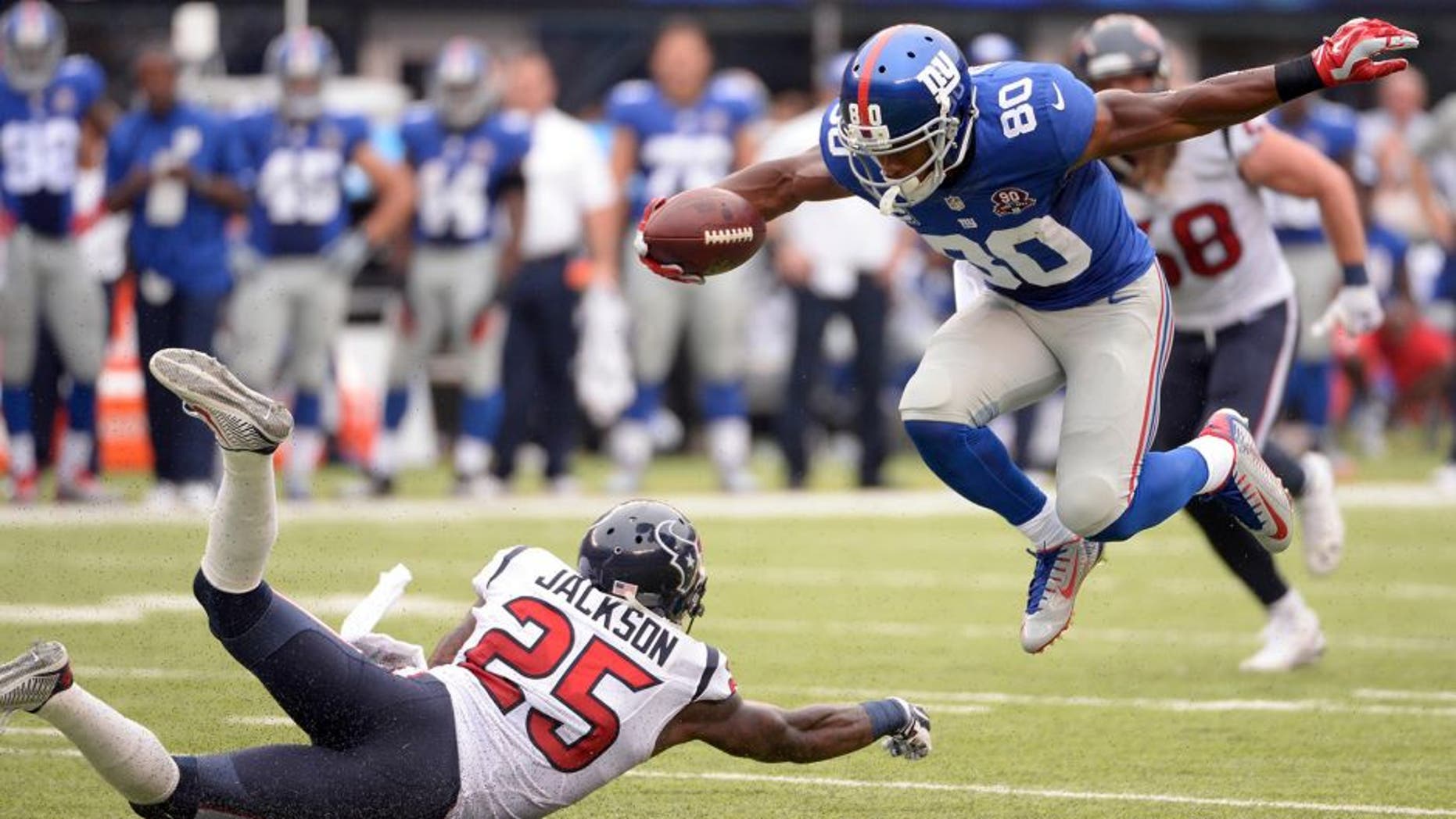 Sep 21, 2014; East Rutherford, NJ, USA; New York Giants wide receiver Victor Cruz (80) scores a touchdown past Houston Texans cornerback Kareem Jackson (25) at MetLife Stadium. Mandatory Credit: Robert Deutsch-USA TODAY Sports