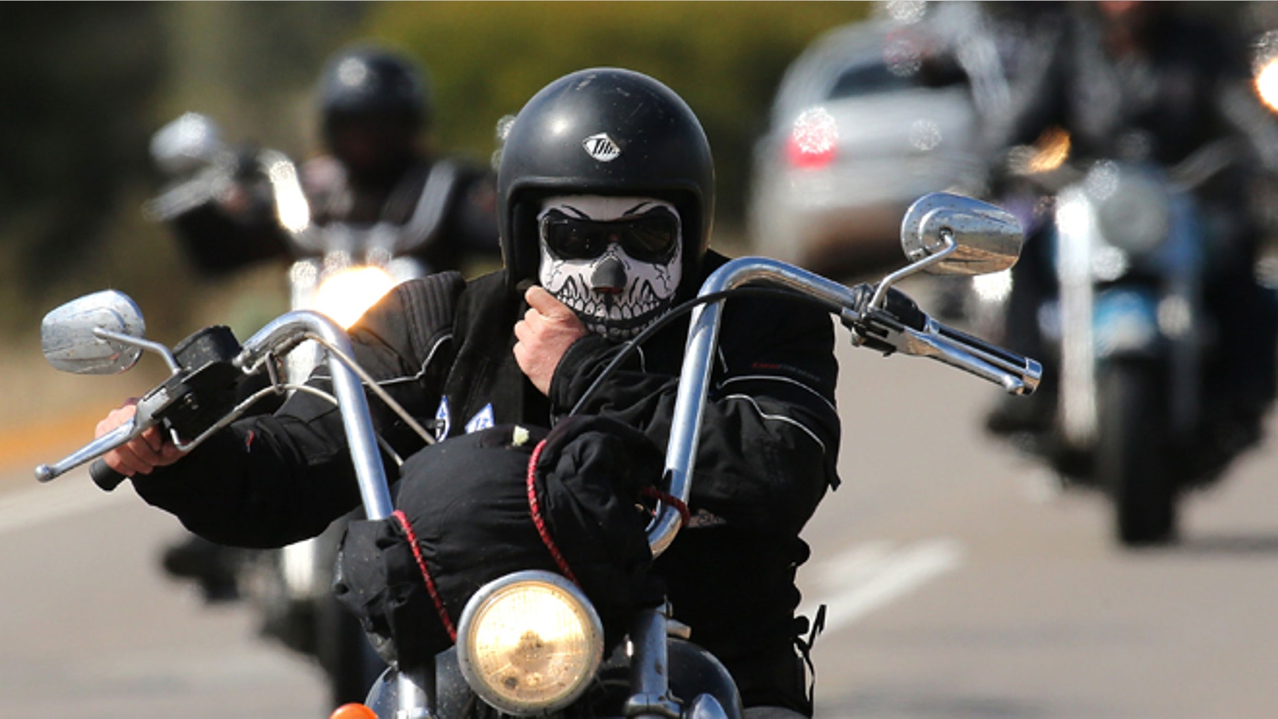 PERTH, AUSTRALIA - SEPTEMBER 12: A Rebels motorcycle club member rides from Meckering to Perth on September 12, 2013 in Perth, Australia. An estimated 1000 Rebels from chapters all over Australia gather for the road trip across the country to Perth. (Photo by Paul Kane/Getty Images)