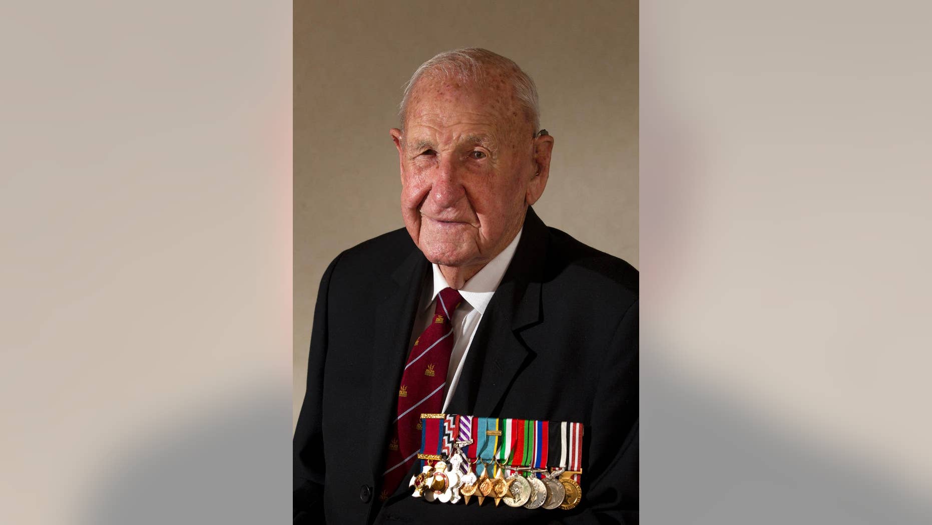 In this March 3, 2015, photo, veteran Les Munro poses for a photo at his home in Tauranga, New Zealand. Munro, 96, the last surviving pilot from the specialized World War II “Dambuster” mission targeting German infrastructure died Tuesday, Aug. 4, 2015. (Alan Gibson/New Zealand Herald via AP) NEW ZEALAND OUT, AUSTRALIA OUT