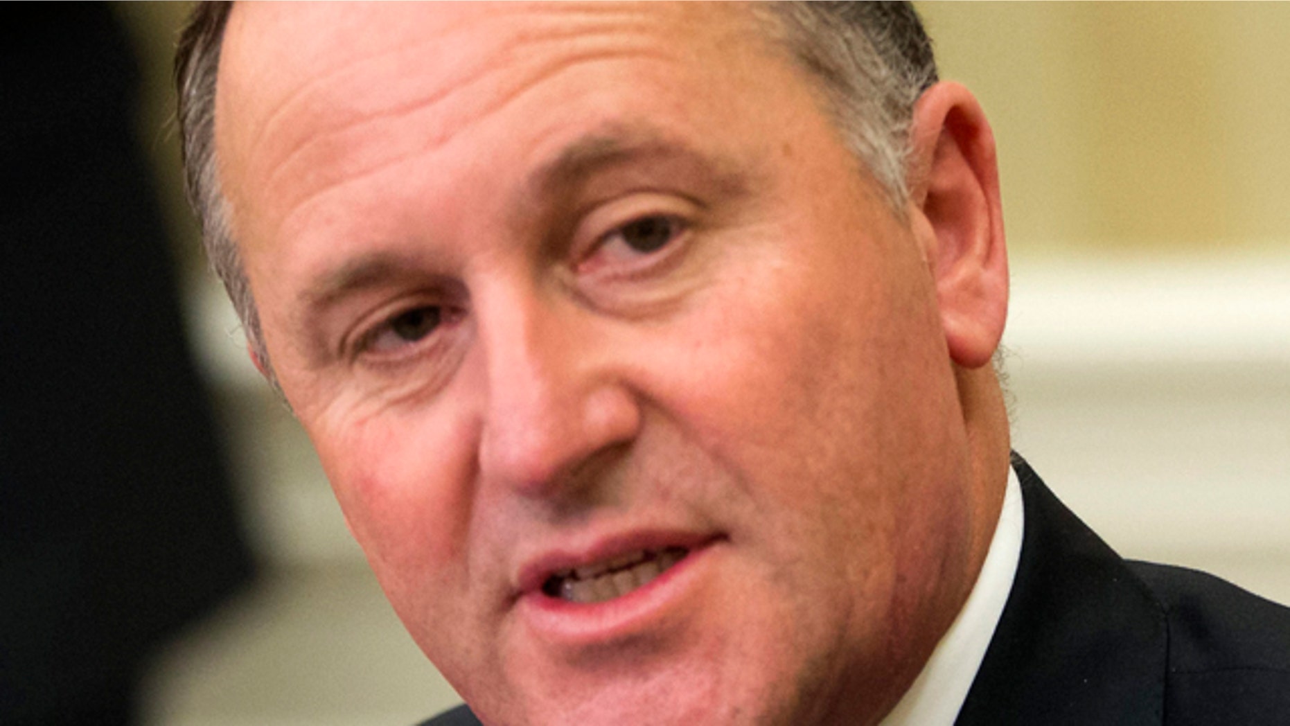 FILE - In this June 20, 2014 file photo, New Zealand's Prime Minister John Key listens to U.S. President Barack Obama in the Oval Office. Key apologized to a cafe worker who said he'd repeatedly pulled her ponytail when he visited the cafe near his home over a period of months, even after she'd told him to stop. (AP Photo/Pablo Martinez Monsivais, File)