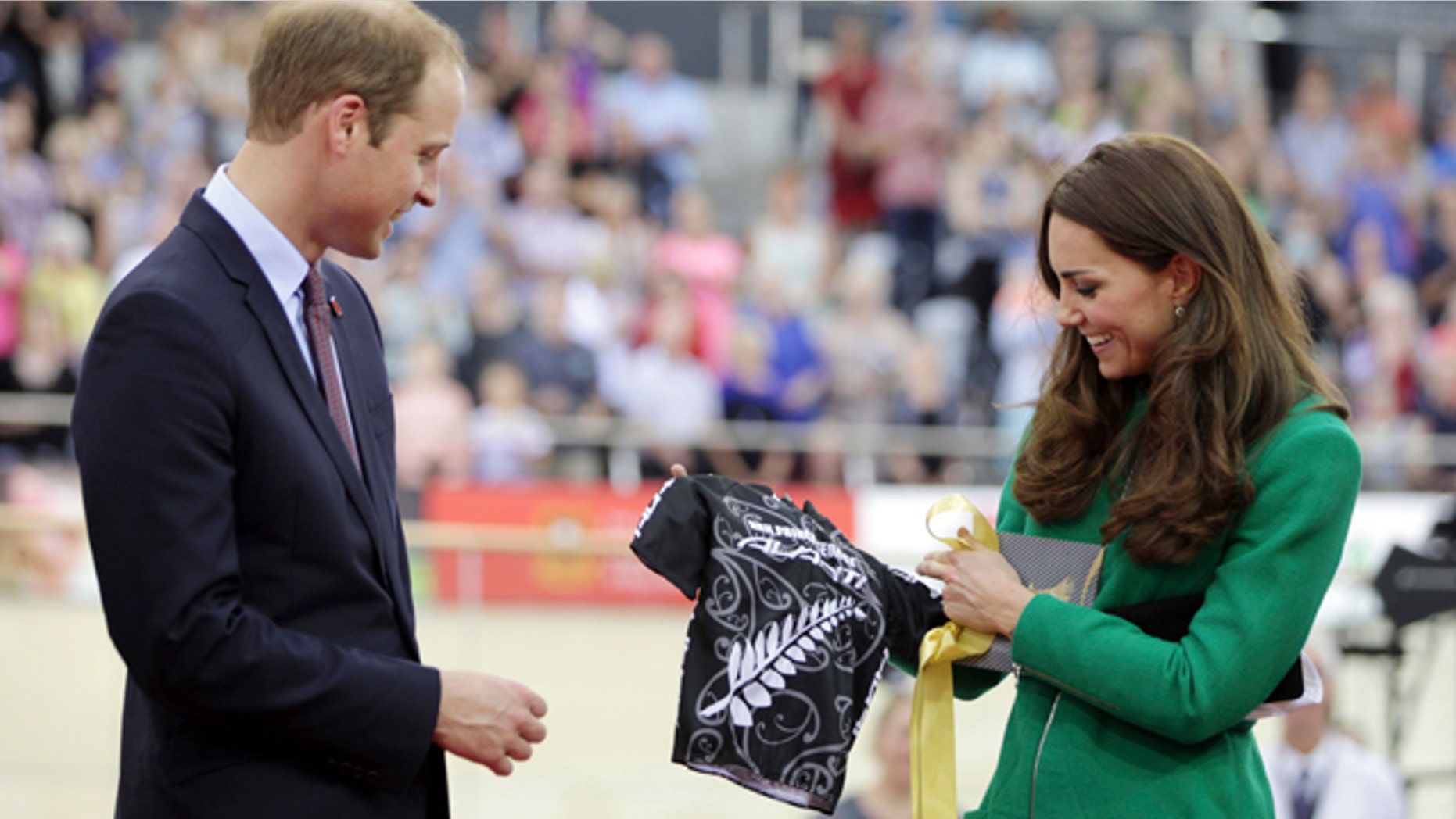 April 12, 2014: Britain's Prince William, left, and Kate, Duchess of Cambridge, look at a cycling shirt presented to them for their son Prince George while attending the opening of the National Cycling Centre in Cambridge, New Zealand. (AP Photo/Peter Drury, Pool)