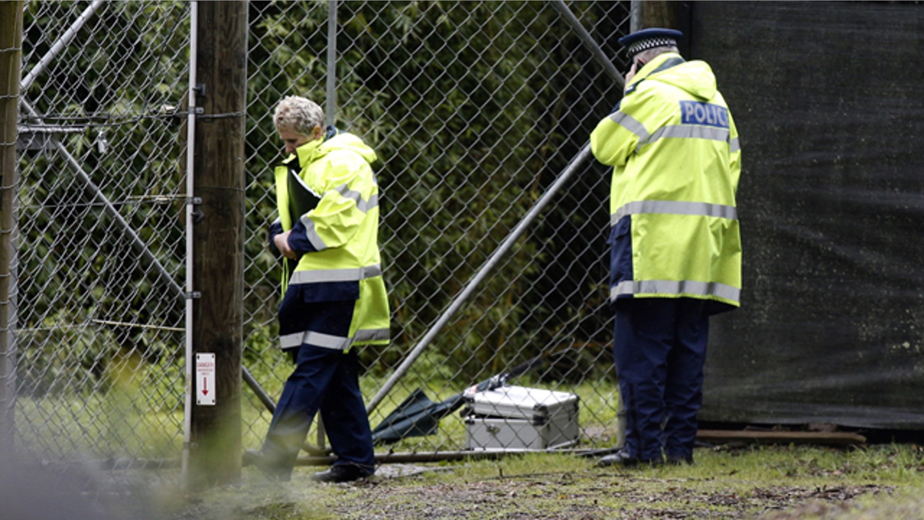 Sept. 20, 2015: Police stand at the shut gates at the Hamilton (New Zealand) Zoo after a female zookeeper was killed by one of its tigers. Police said the woman died at the scene, and asked the zoo to order all visitors to leave and close its doors until Thursday. (Nick Reed/New Zealand Herald via AP).