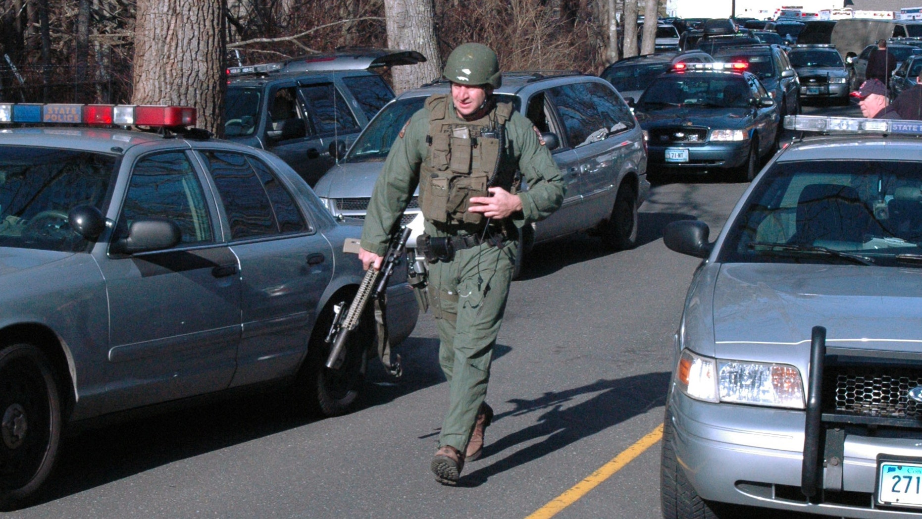 Dec. 14, 2012: In this photo provided by the Newtown Bee, police officers are on the scene outside Sandy Hook Elementary School in Newtown, Conn., where authorities say a gunman opened fire, killing 26 people, including 20 children.