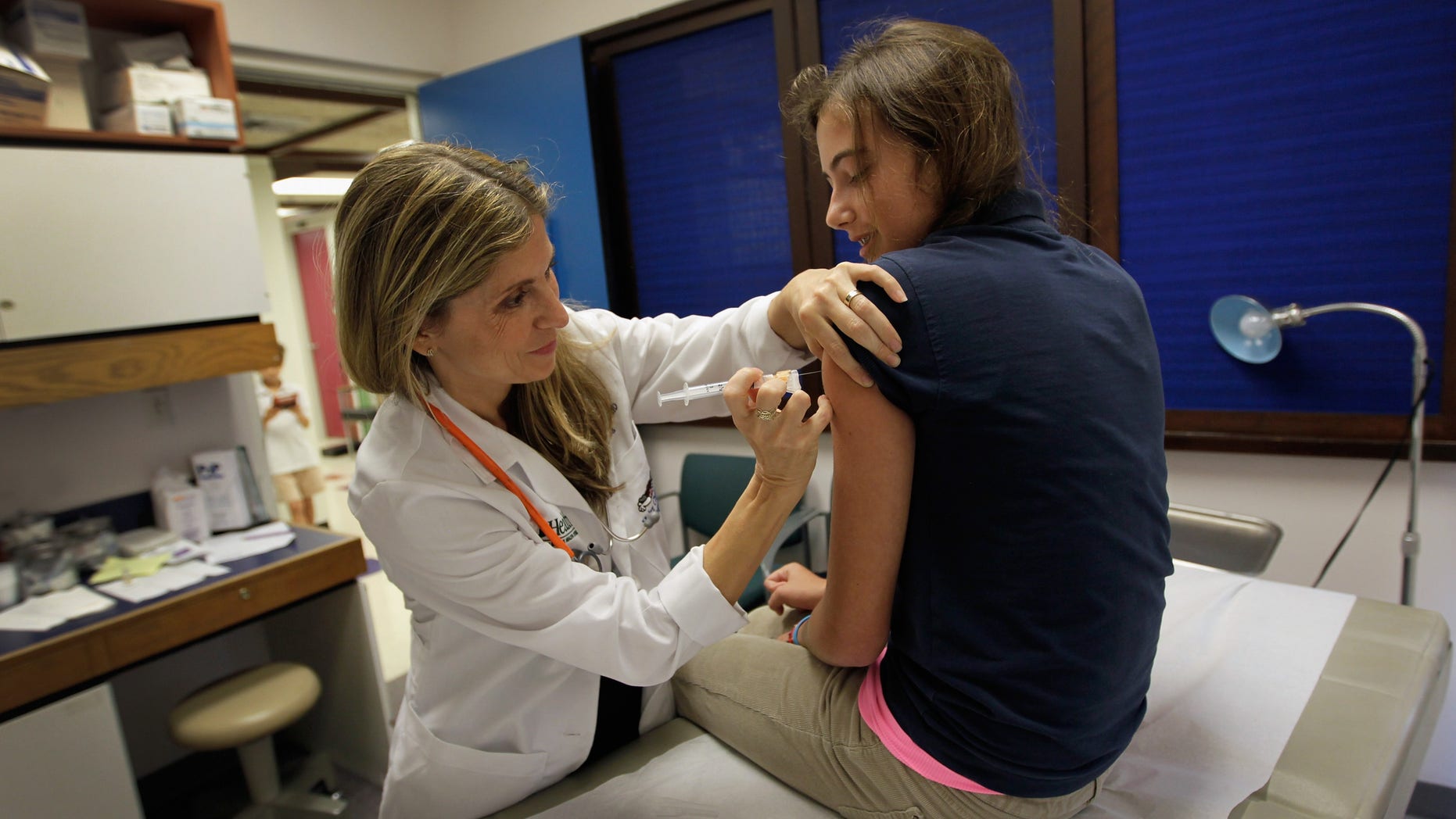 MIAMI, FL - SEPTEMBER 21: University of Miami pediatrician Judith L. Schaechter, M.D. (L) gives an HPV vaccination to a 13-year-old girl in her office at the Miller School of Medicine on September 21, 2011 in Miami, Florida. The vaccine for human papillomavirus, or HPV, is given to prevent a sexually transmitted infection that can cause cancer. Recently the issue of the vaccination came up during the Republican race for president when Rep. Michele Bachmann (R-MN) called the vaccine to prevent cervical cancer "dangerous" and said that it may cause mental retardation, but expert opinion in the medical field contradicts her claim. Texas Gov. Rick Perry, also a presidential contender, has taken heat from some within his party for presiding over a vaccination program in his home state. (Photo by Joe Raedle/Getty Images)