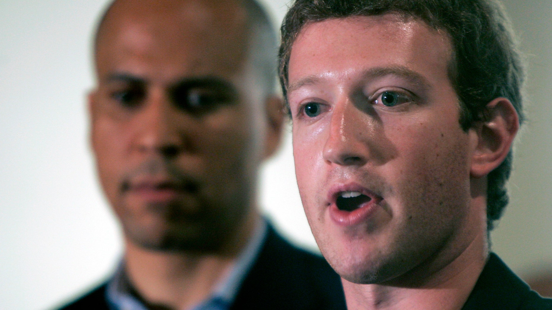 FILE - In this Sept. 25, 2010 file photo, Mark Zuckerberg, right, founder and CEO of Facebook talks about his donation of $100 million to help Newark public schools during a news conference in Newark, N.J. With Zuckerberg is Newark mayor Cory Booker and N.J. Gov. Chris Christie, not in picture. More than three years after Zuckerberg committed $100 million toward remaking Newarks struggling schools, the district is engulfed in a dispute over proposed large-scale teacher layoffs that is threatening to derail wider reform efforts. (AP Photo/Rich Schultz)