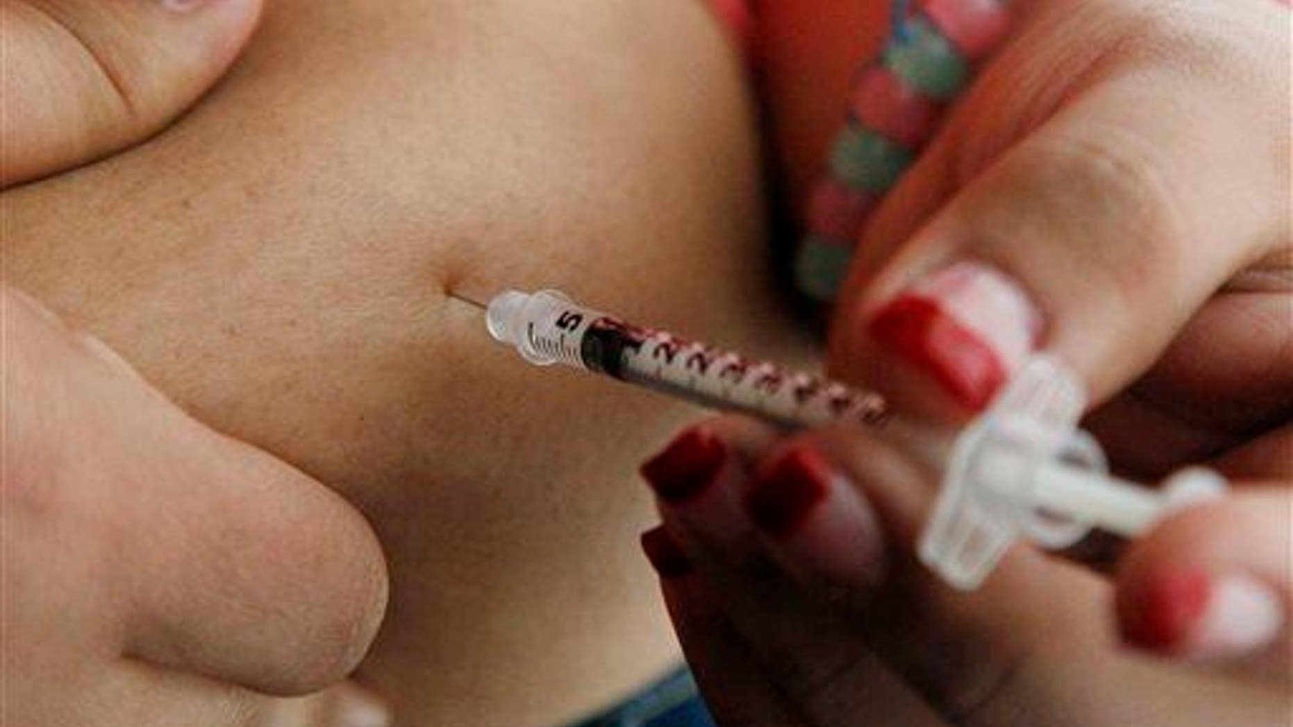 In this April 29, 2012, file photo, a 19-year-old diagnosed with diabetes gives herself an injection of insulin at her home in the Los Angeles suburb of Commerce.