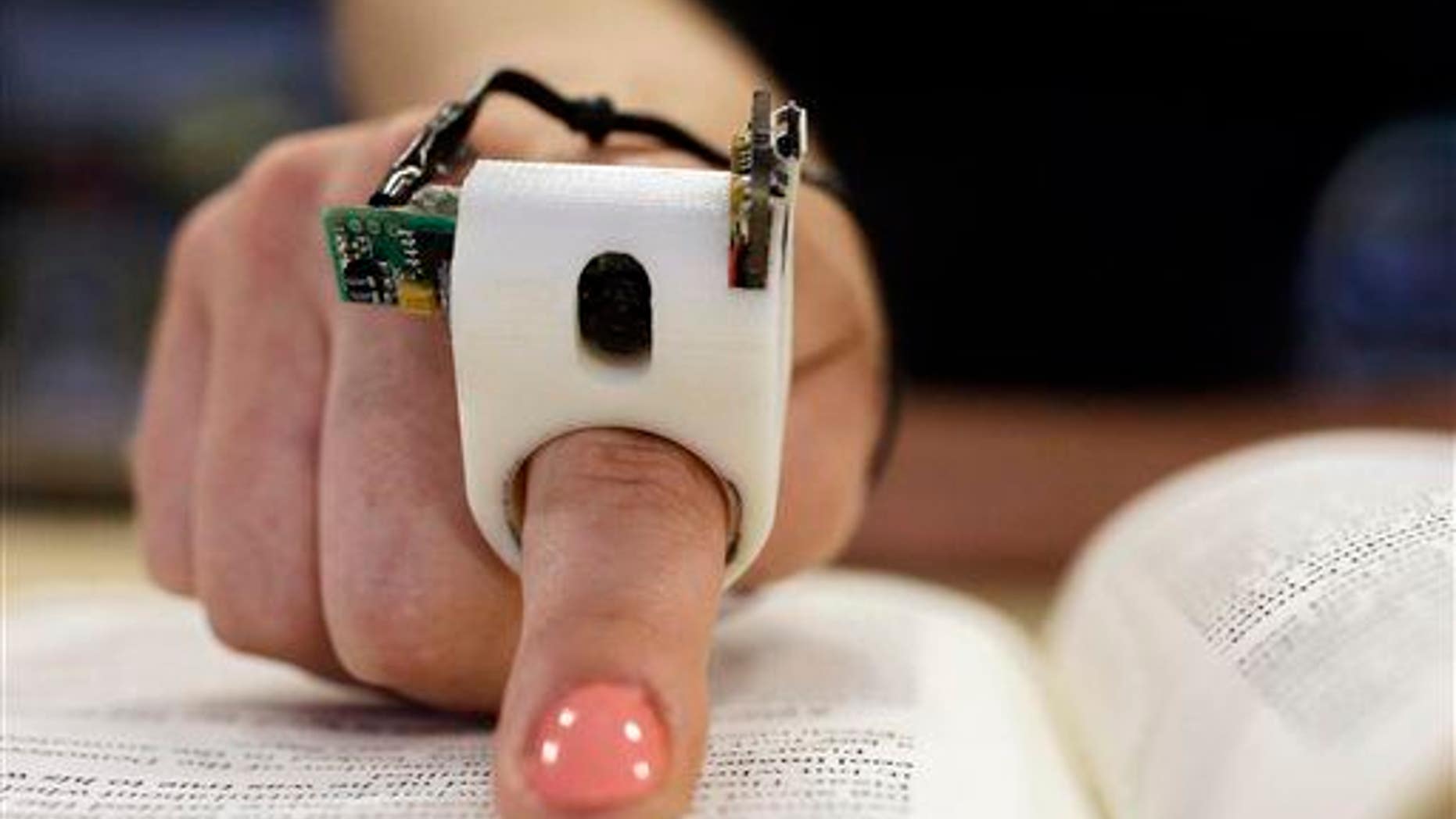 The device uses a camera to capture text, which is then converted into speech.