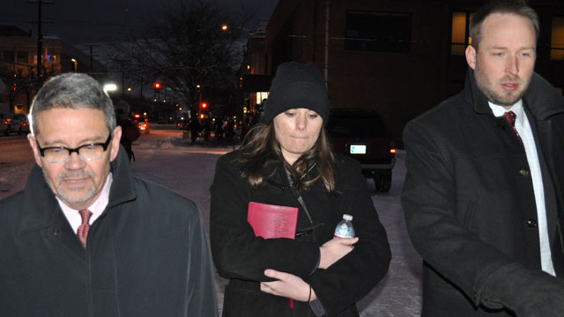 FILE - In this Tuesday, Dec. 10, 2013 file photo, Jordan Graham, center, is flanked by defense attorneys Michael Donahoe, left, and Andy Nelson, as she leaves court in Missoula, Mont. The Montana woman who was to be sentenced Thursday for pushing her new husband to his death in Glacier National Park wants to withdraw her guilty plea to a second-degree murder charge, her lawyer said Tuesday March 25, 2014. (AP Photo/Stephan Ferry, File)
