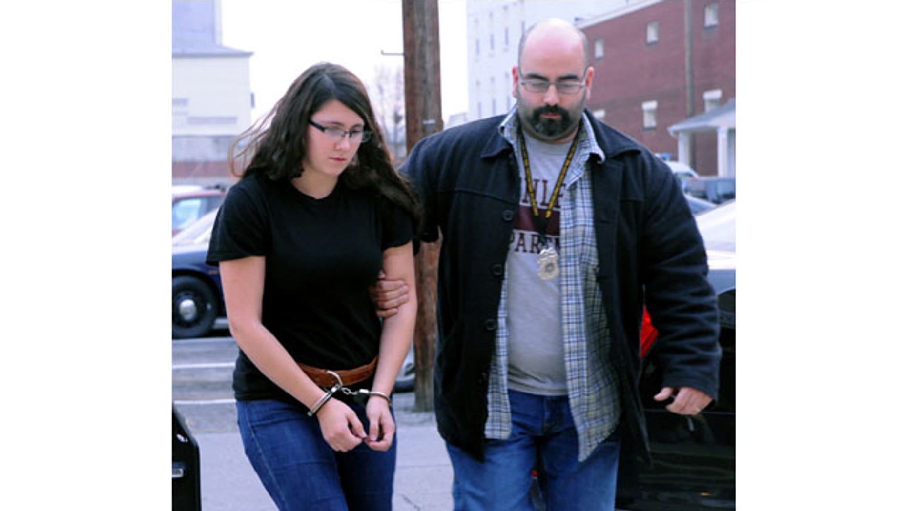 FILE - In this Tuesday, Dec. 3, 2013 file photo, Miranda K. Barbour is led into District Judge Ben Apfelbaum's office in Sunbury, Pa., by Sunbury policeman Travis Bremigen. Authorities say police have yet to substantiate Bremigen's claim that she killed more than 20 people in four states before the murder she is now charged with committing. (AP)