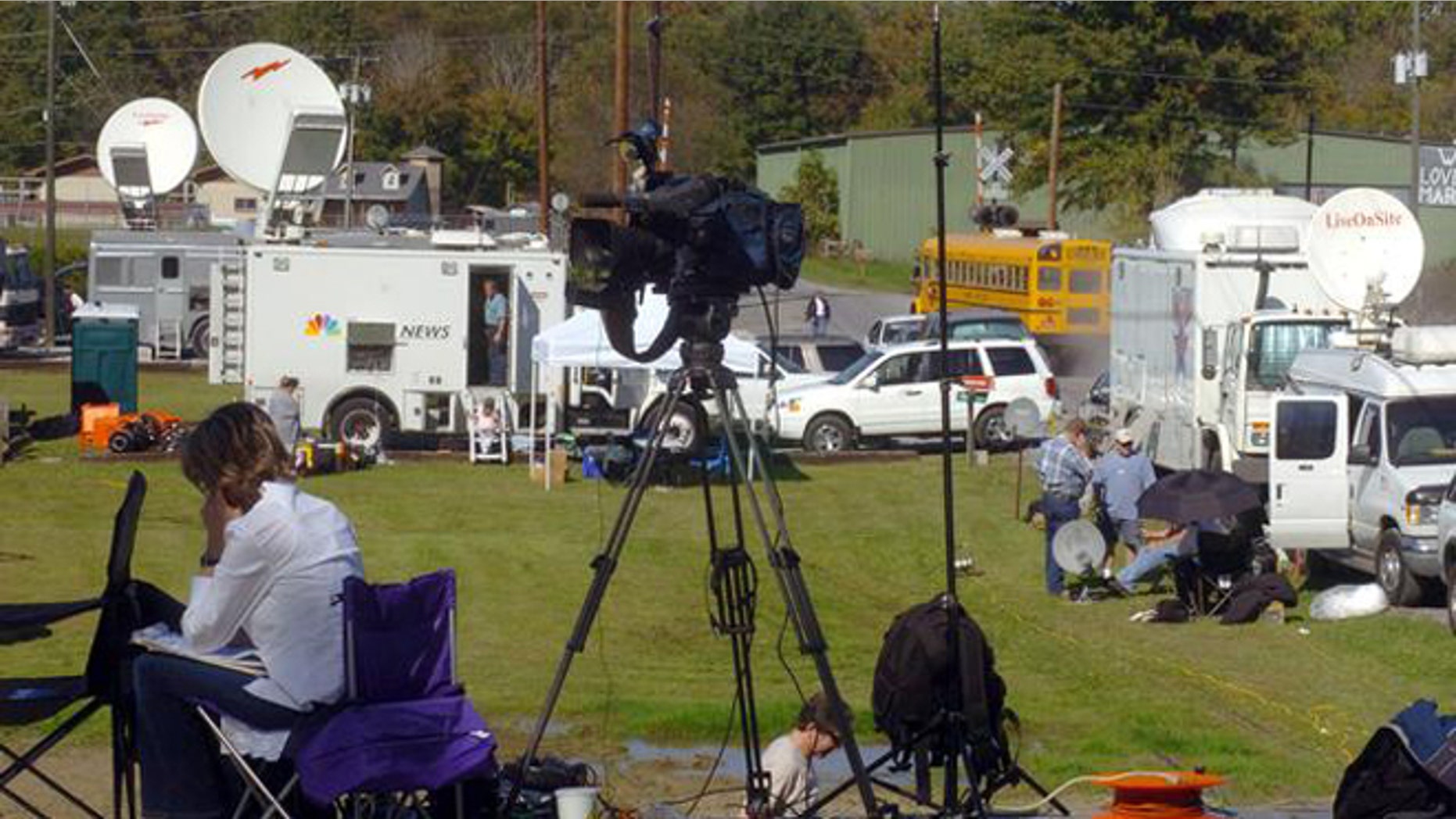 Media outlets, from networks to newspapers, stake out the entrance to the Alderson Prison Camp in Alderson, W.Va., on Oct. 6, 2004. Martha Stewart will become the facilities newest inmate sometime this week. In the background, Jef Harris' Vintage Log and Lumber displays a sign showing his support for Martha Stewart. (AP Photo/Jon C. Hancock)
