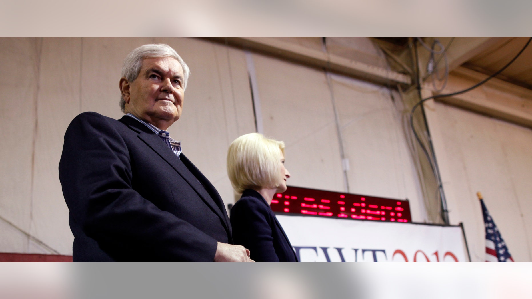 Republican presidential candidate former Speaker Newt Gingrich, stands with his wife Callista as he is introduced at his campaign headquarters in Davenport, Iowa, Monday, Jan. 2, 2012. (AP Photo/Charles Dharapak)