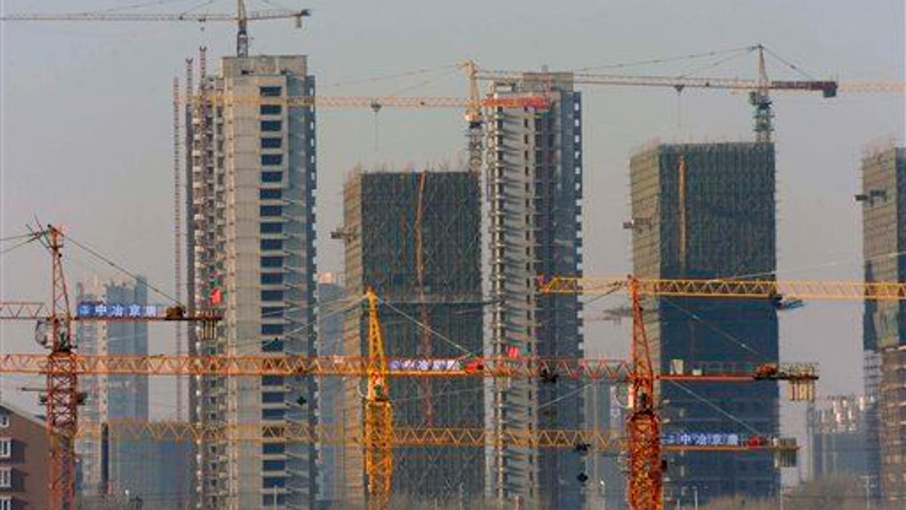 A housing development under construction in Shenyang, China, in 2009. "Ghost cities" have sprung up around the country as developers struggle to fill units.