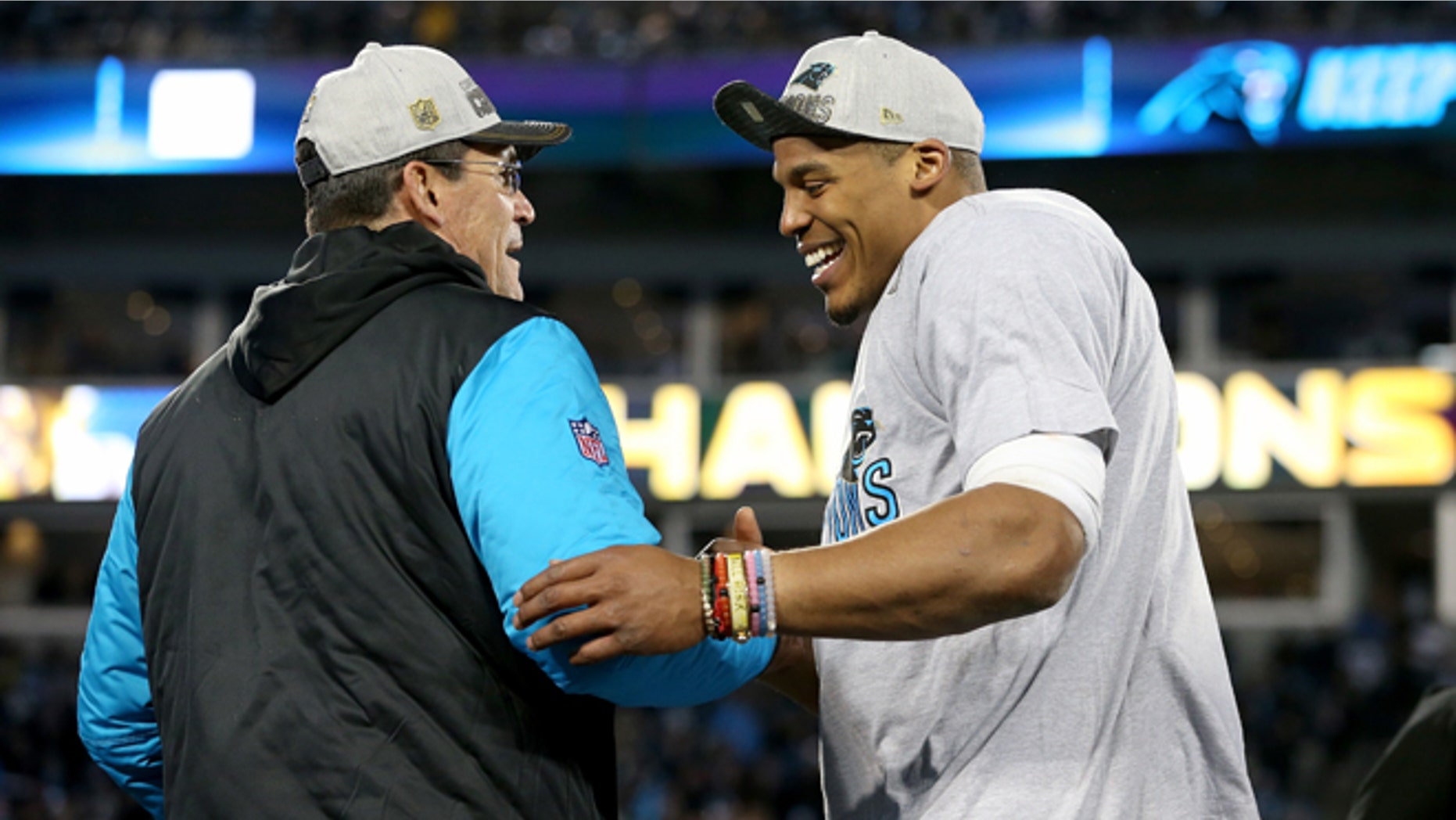 CHARLOTTE, NC - JANUARY 24: Head coach Ron Rivera of the Carolina Panthers celebrates with Cam Newton #1 after defeating the Arizona Cardinals with a score of 49 to 15 to win the NFC Championship Game at Bank of America Stadium on January 24, 2016 in Charlotte, North Carolina. (Photo by Streeter Lecka/Getty Images)