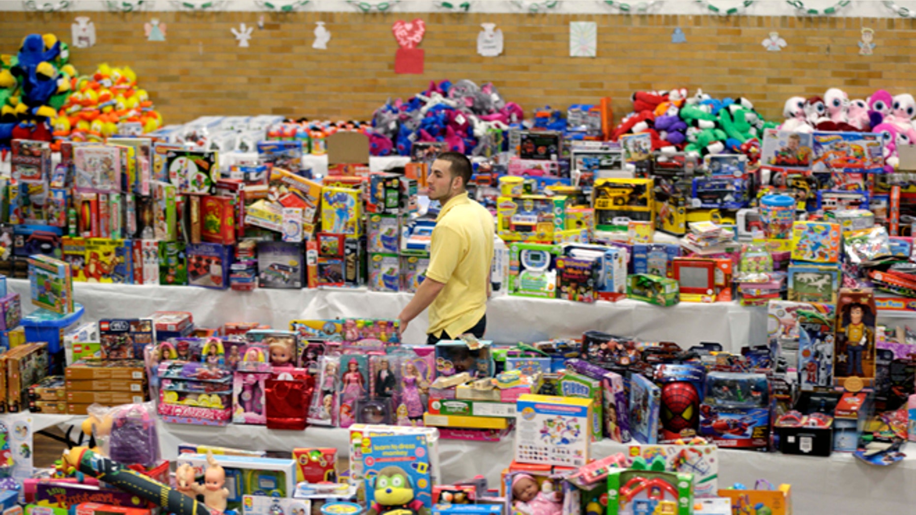 Dec. 21, 2012: Volunteer Anthony Vessicchio of East Haven, Conn., helps to sort tables full of donated toys at the town hall in Newtown, Conn.