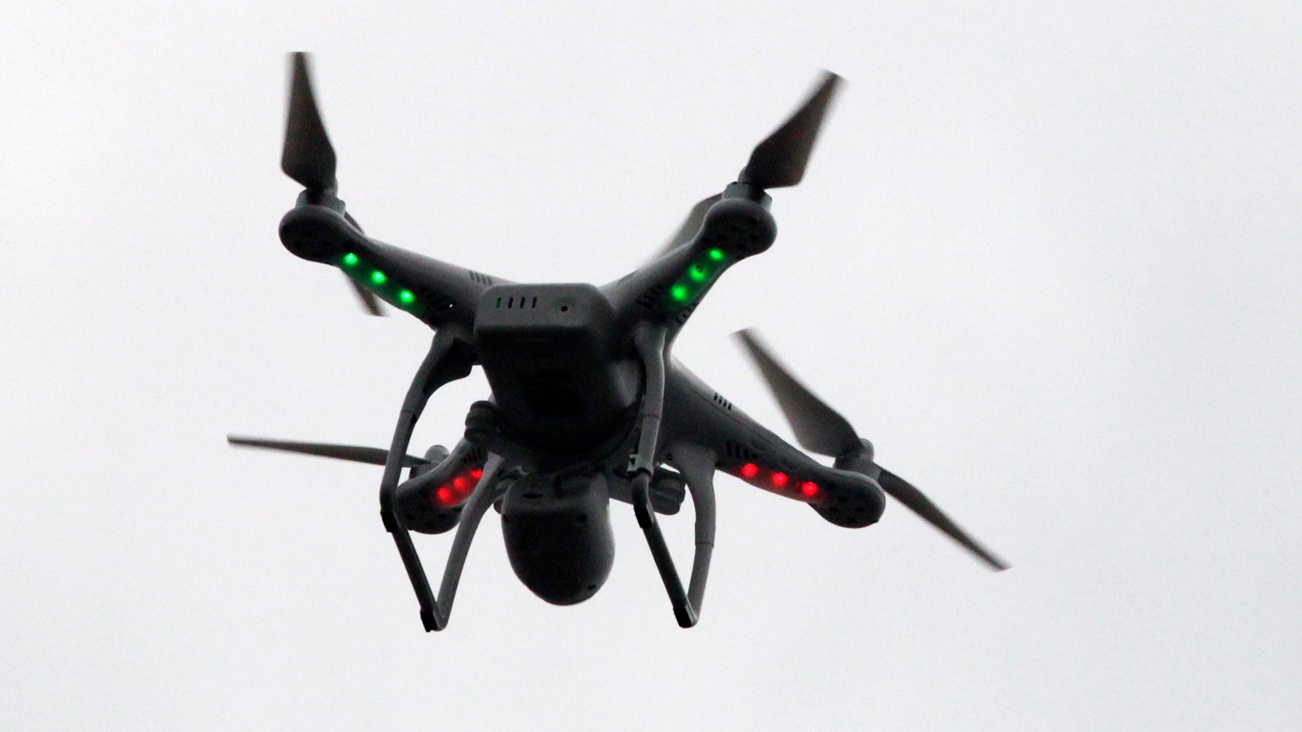 FILE - In this March 12, 2014 file photo, a drone prepares to land after flying over the scene of an explosion that leveled two apartment buildings in East Harlem in New York. When government officials designed a new air traffic control system, they neglected to take something into account _ drones. The FAA has already spent over a decade and more than $5 billion on the complex and ambitious new system dubbed NextGen, and is nearly finished installing hardware and software for several key systems. But with demand to fly unmanned aircraft escalating, there are questions about whether the new air traffic system will be able to accommodate them. The farther along the program gets, the more difficult it becomes to go back and make changes. The program isnt expected to be completed for at least another decade. (AP Photo/Mark Lennihan, File)