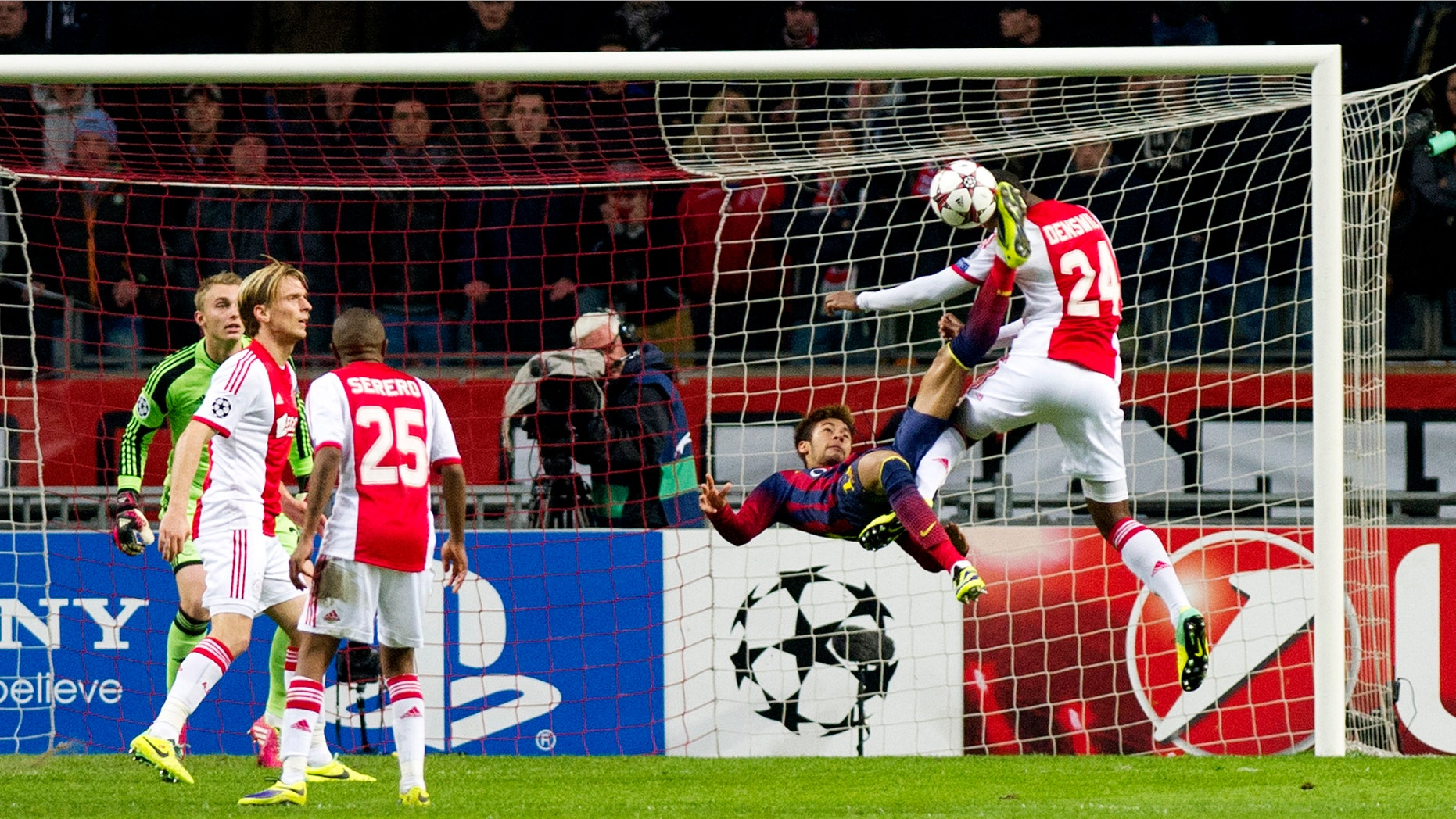 Barcelona's Neymar, second right, challenges Ajax's Stefano Denswil, first right, during the Group H Champions League soccer match between Ajax and FC Barcelona at the ArenA stadium in Amsterdam, Netherlands, Tuesday Nov. 26, 2013. (AP Photo/Patrick Post)