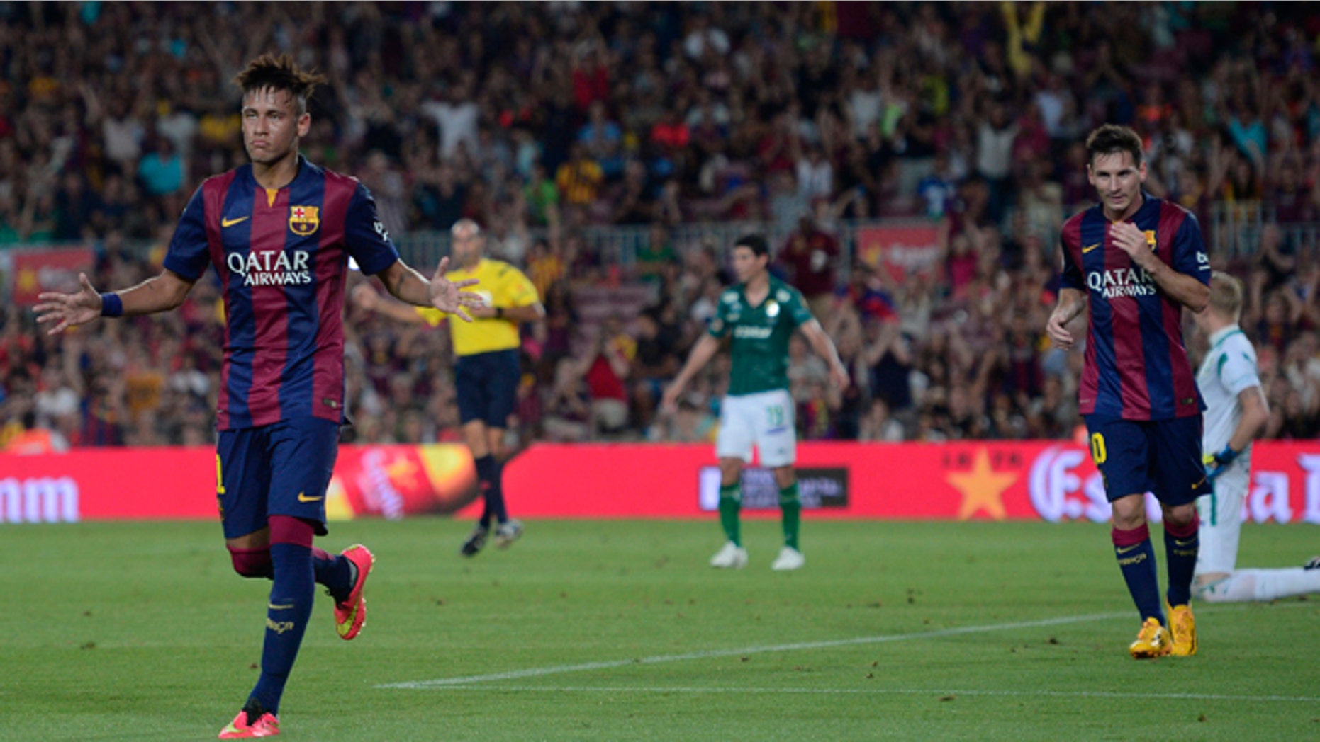 Barcelona's Neymar, from Brazil, left, reacts after scoring against Leon during the Joan Gamper trophy friendly soccer match at the Camp Nou in Barcelona, Spain, Monday, Aug. 18, 2014. (AP Photo/Manu Fernandez)