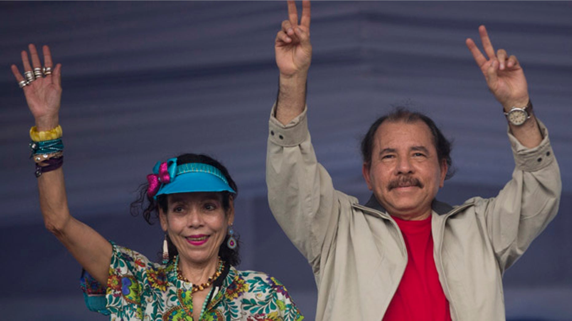 FILE.- In this July 3, 2016 file photo Nicaragua's President Daniel Ortega, right, and first lady Rosario Murillo, wave to supporters during an event commemorating the 36th anniversary of the Sandinista National Liberation Front withdrawal to Masaya, in Managua, Nicaragua. Murillo now running as her husband's VP ticket mate in a Nov. 6 election seen as a shoo-in and is poised to finally have the title to match her true influence. (AP Photo/Esteban Felix, File)