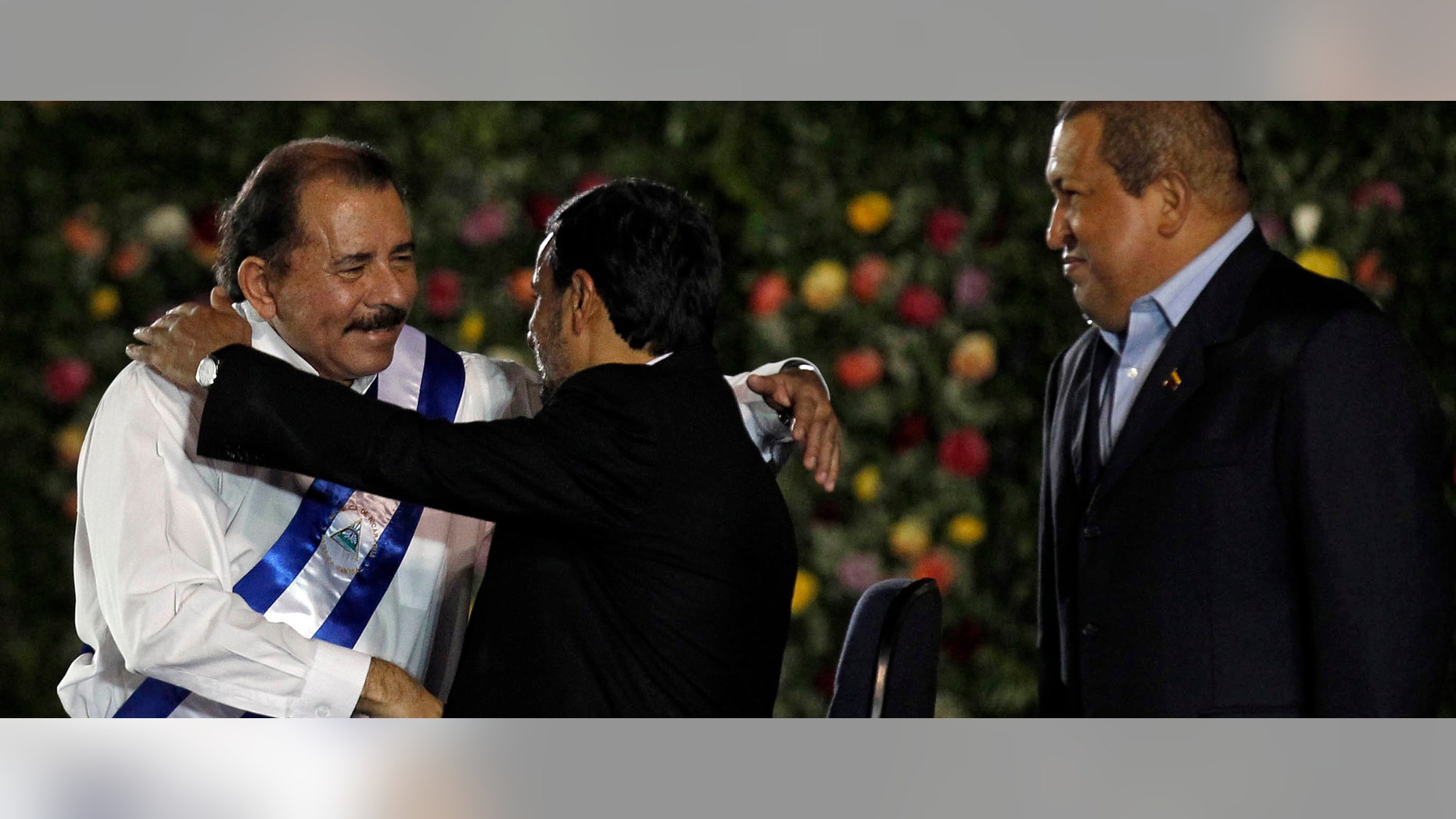 Nicaraguas President Daniel Ortega, left, is congratulated by Iran's President Mahmoud Ahmadinejad as Venezuela's President Hugo Chavez, right, looks on after Ortega was sworn in for a third term at the swearing-in ceremony in Managua, Nicaragua, Tuesday Jan. 10, 2012. (AP Photo/Esteban Felix)