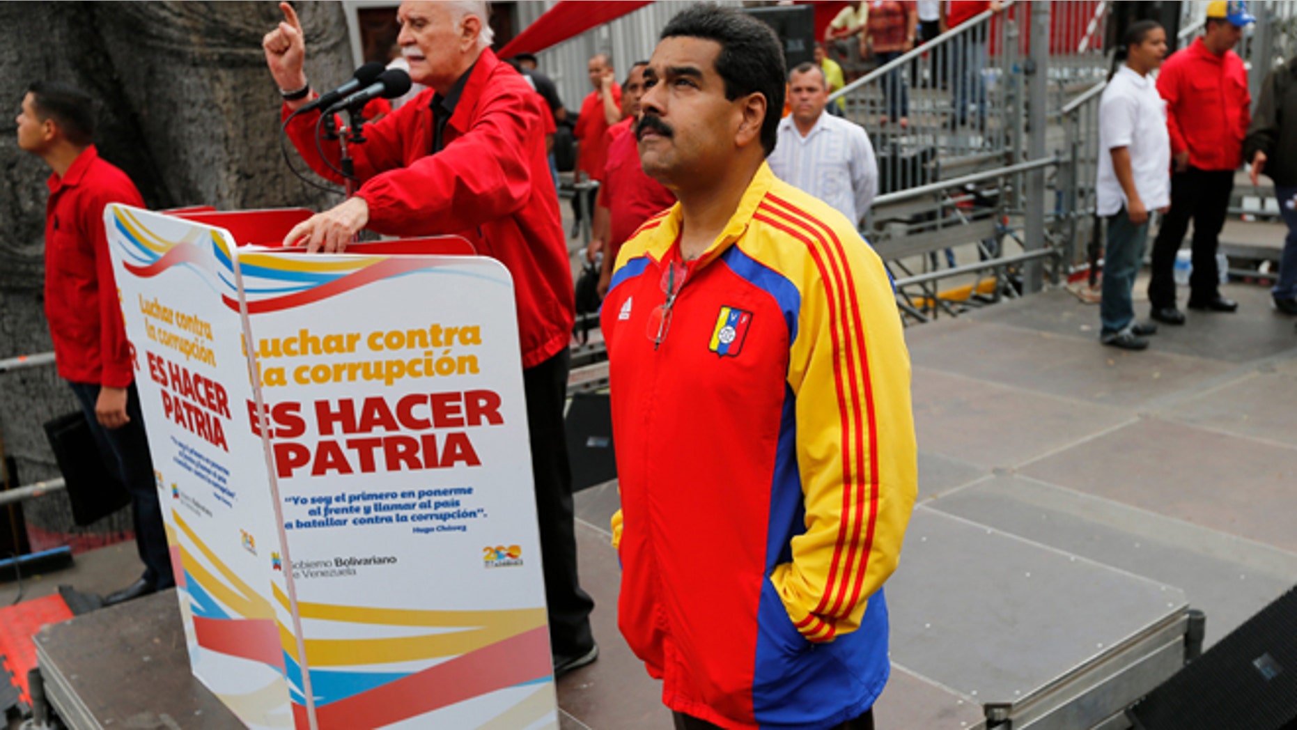 Venezuela's President Nicolas Maduro waits his turn to speak during a march against corruption, in Caracas, Venezuela, Aug. 3, 2013.