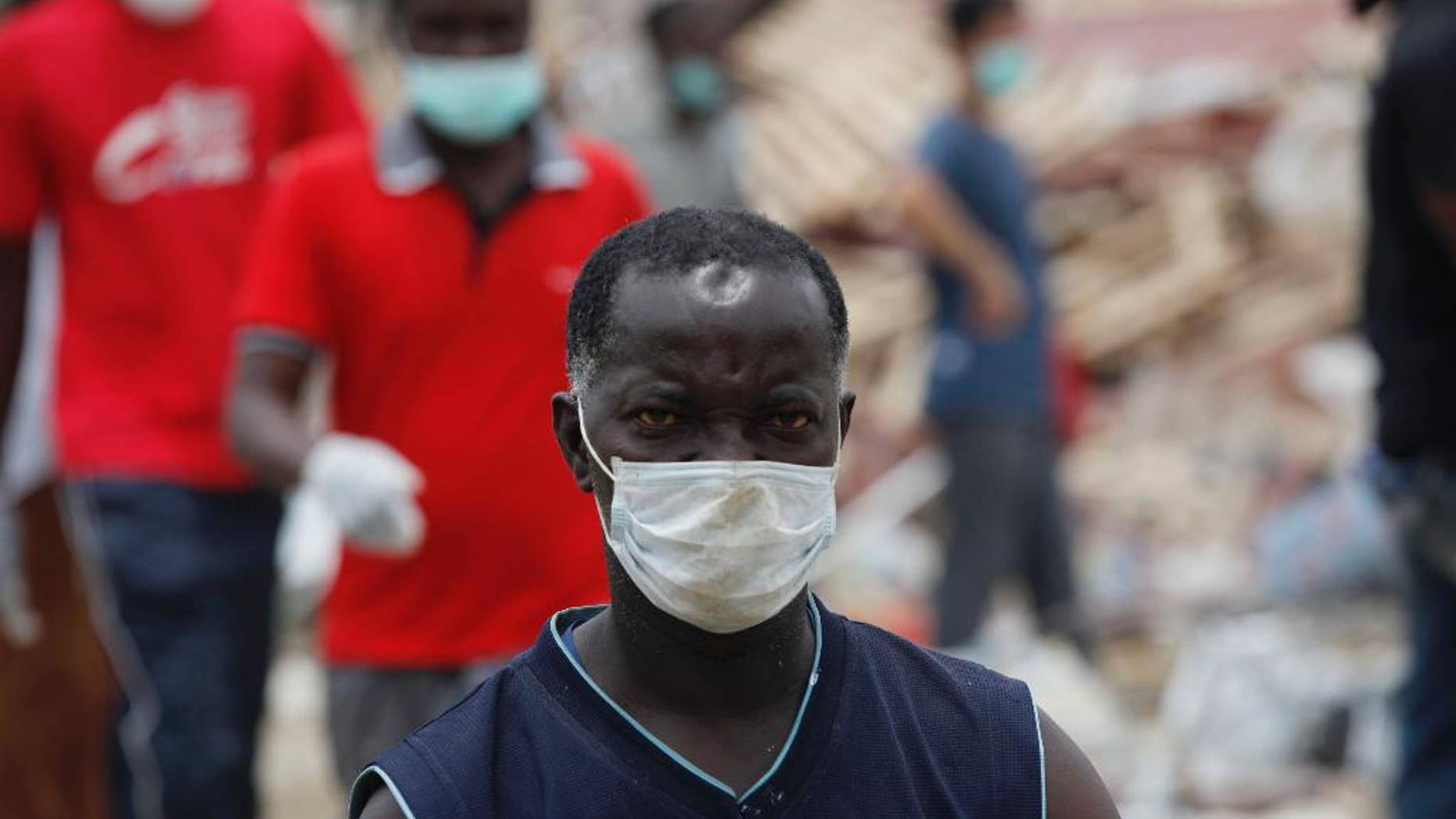 A rescue worker takes part in the search for survivors in the rubble of a collapsed building belonging to the Synagogue Church of All Nations in Lagos, Nigeria Wednesday, Sept. 17, 2014. A Nigerian televangelist whose followers across Africa and beyond believe he has powers of healing and prophesy is now beset by crisis after one of his buildings collapsed, killing at least 70 people amid allegations that church officials didn’t cooperate with rescuers. The exact circumstances of the disaster as well as the death toll remained unclear on Wednesday, five days after the disaster at a multistory guesthouse and shopping area for T.B. Joshua's Synagogue, Church of All Nations, on the outskirts of Lagos, Nigeria's commercial capital. ( AP Photo/Sunday Alamba)