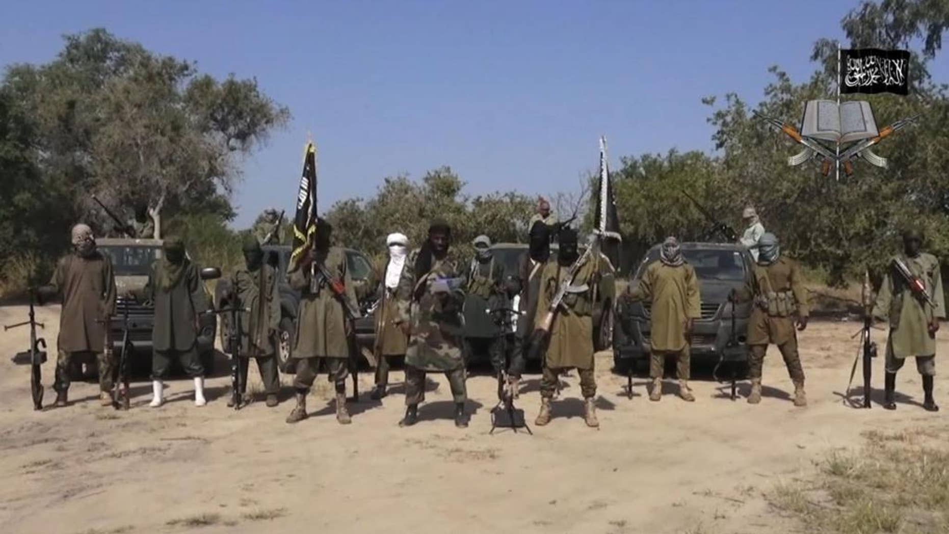 FILE - In his file image taken from video released late Friday evening, Oct. 31, 2014, by Boko Haram, Abubakar Shekau, centre, the leader of Nigeria's Islamic extremist group. Boko Haram fighters have shot or burned to death about 90 civilians and wounded 500 in ongoing fighting in a Cameroonian border town near Nigeria, officials in Cameroon said Thursday, Feb. 5, 2015. (AP Photo/Boko Haram,File)