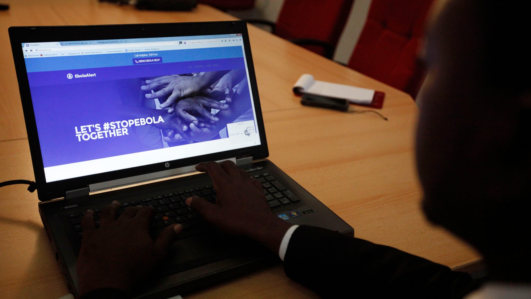 Aug. 25, 2014: Dr. Lawal Bakare, Ebola helpline co-ordinater browse through a website focusing attention on awareness through toll free helplines and social media network to prevent the spread of Ebola. in Lagos, Nigeria.