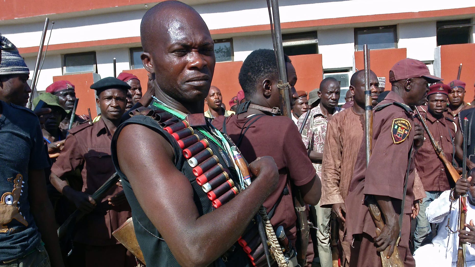 May 18, 2014 - Armed hunters gather before looking for 276 abducted school girls in Maiduguri, Nigeria. Hundreds of hunters armed with homemade rifles, poisoned arrows and amulets say their spiritual powers can lead them to the girls abducted by Islamic extremists.