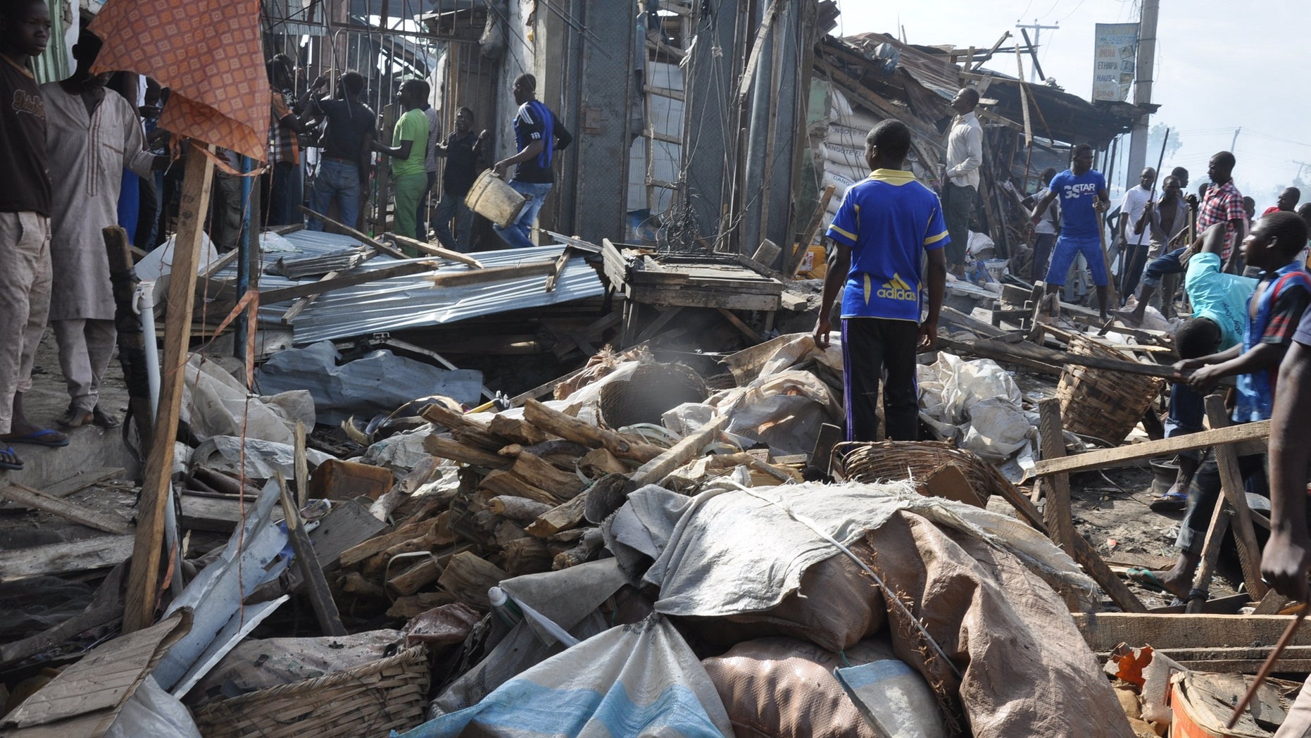 July 1, 2014 - People gather at the scene of a car bomb explosion, at the central market, in Maiduguri, Nigeria. Many blamed Boko Haram, the Islamic extremist group whose birthplace is Maiduguri and which is accused of a series of recent bomb attacks in the West African nation.