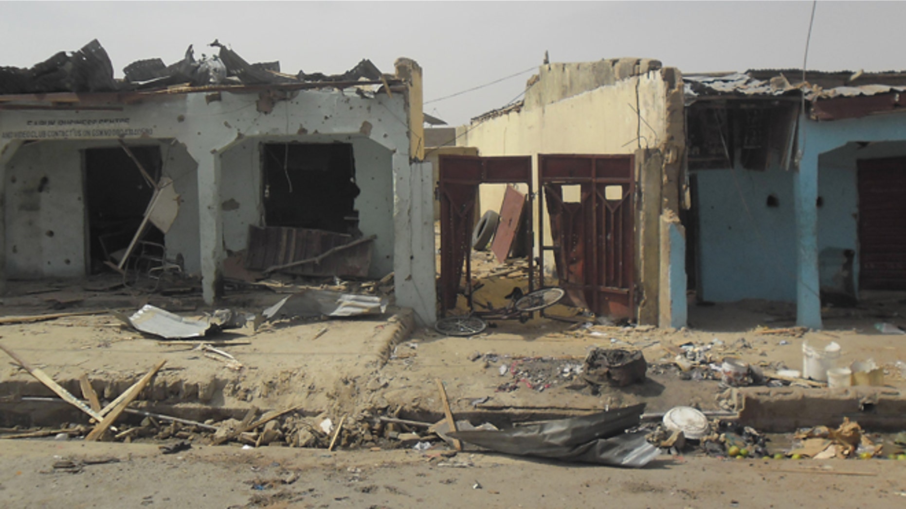 June 18, 2014: Bloodstains seen on the street and damage buildings following a suicide bomb explosion at a World cup viewing center in Damaturu, Nigeria. There was no immediate claim for the blast but Boko Haram was suspected.
