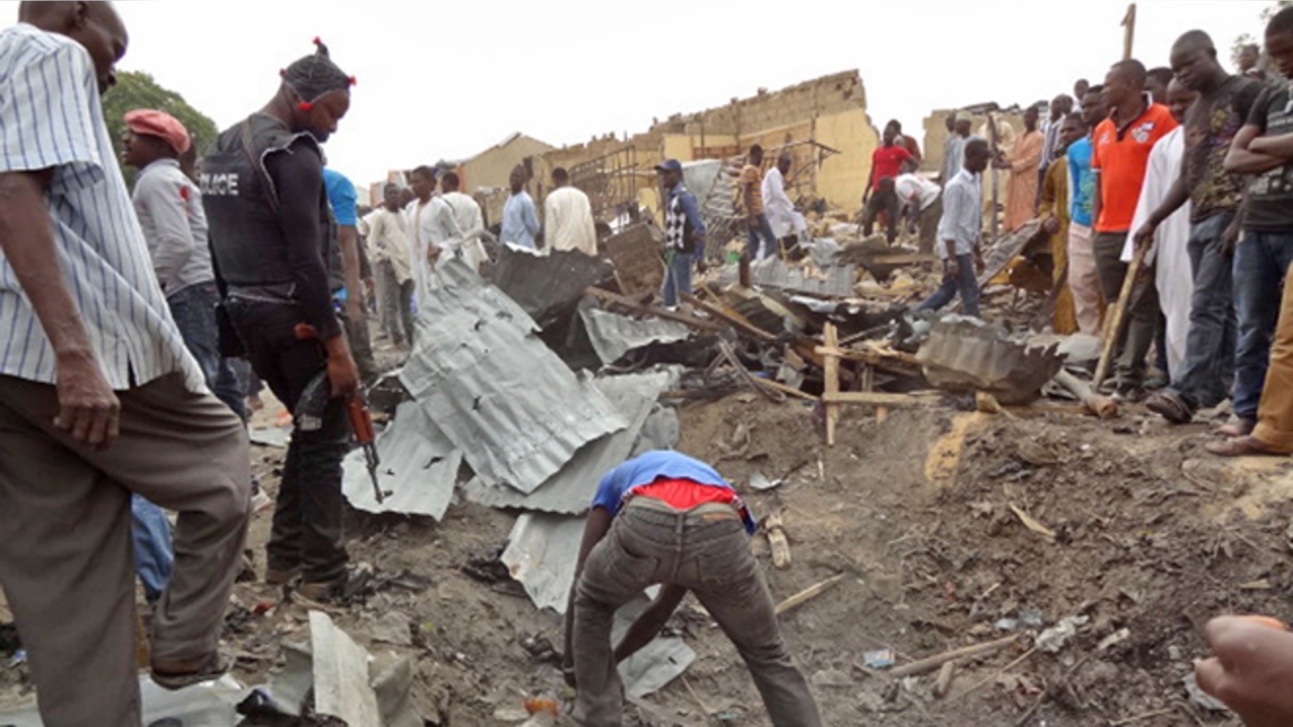 March 2, 2014: People search the area where a twin car bomb exploded in Maiduguri, Nigeria.